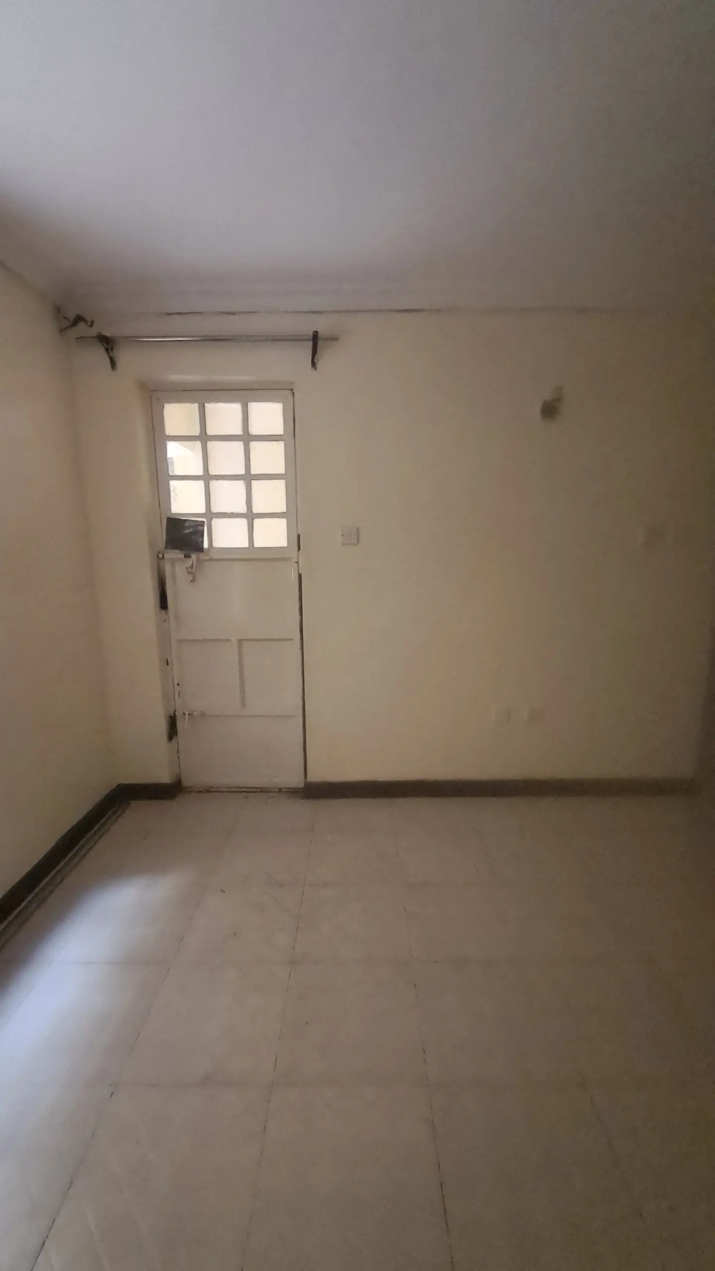 Empty bedroom with white door and natural light