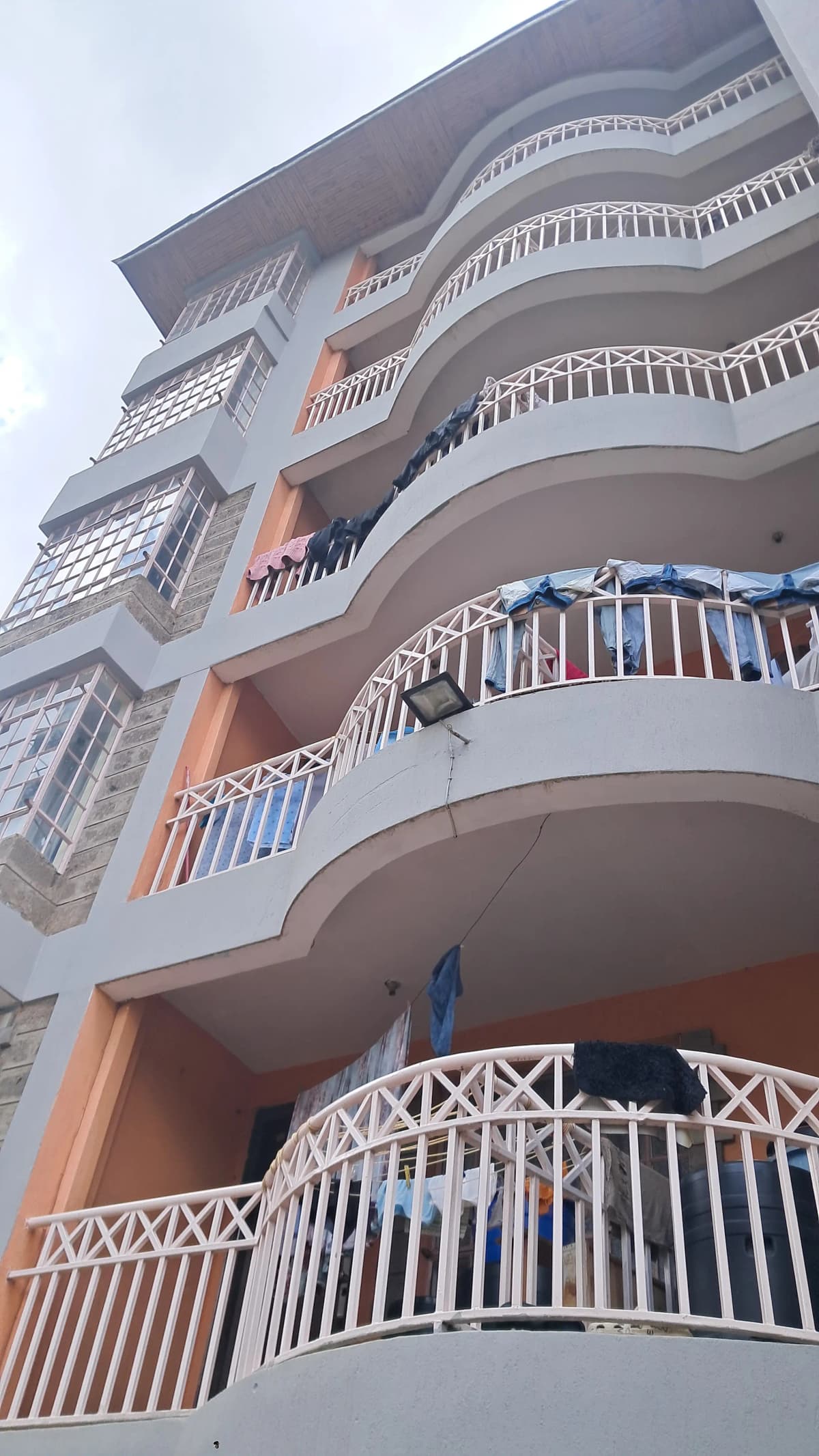 Multi-story residential building facade with curved balconies