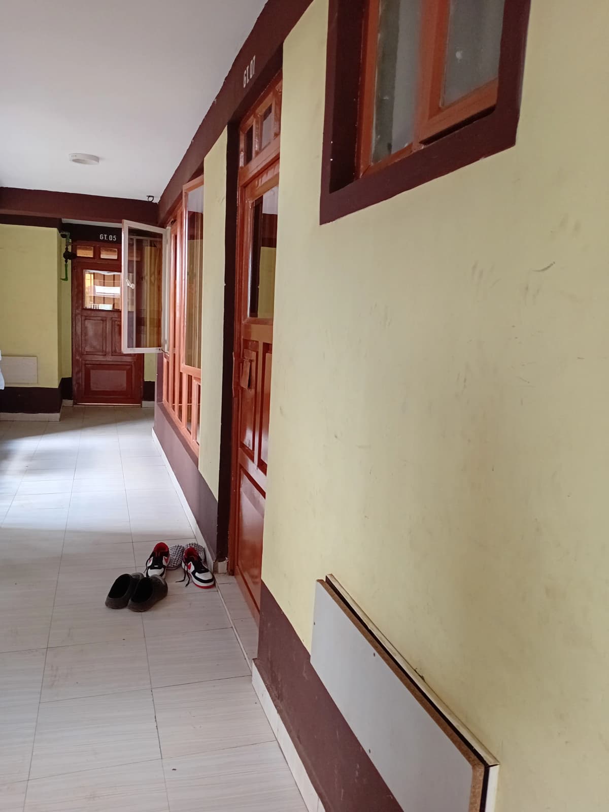 Corridor with burgundy-framed doors and cream walls