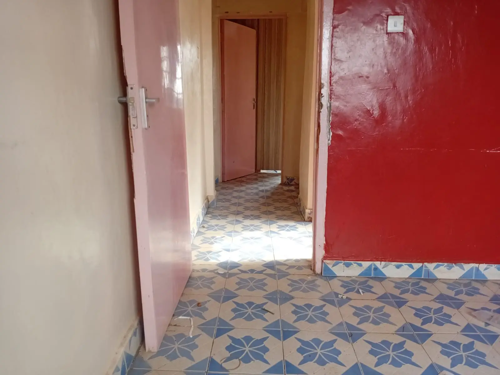 Interior hallway with patterned tile flooring and colored walls