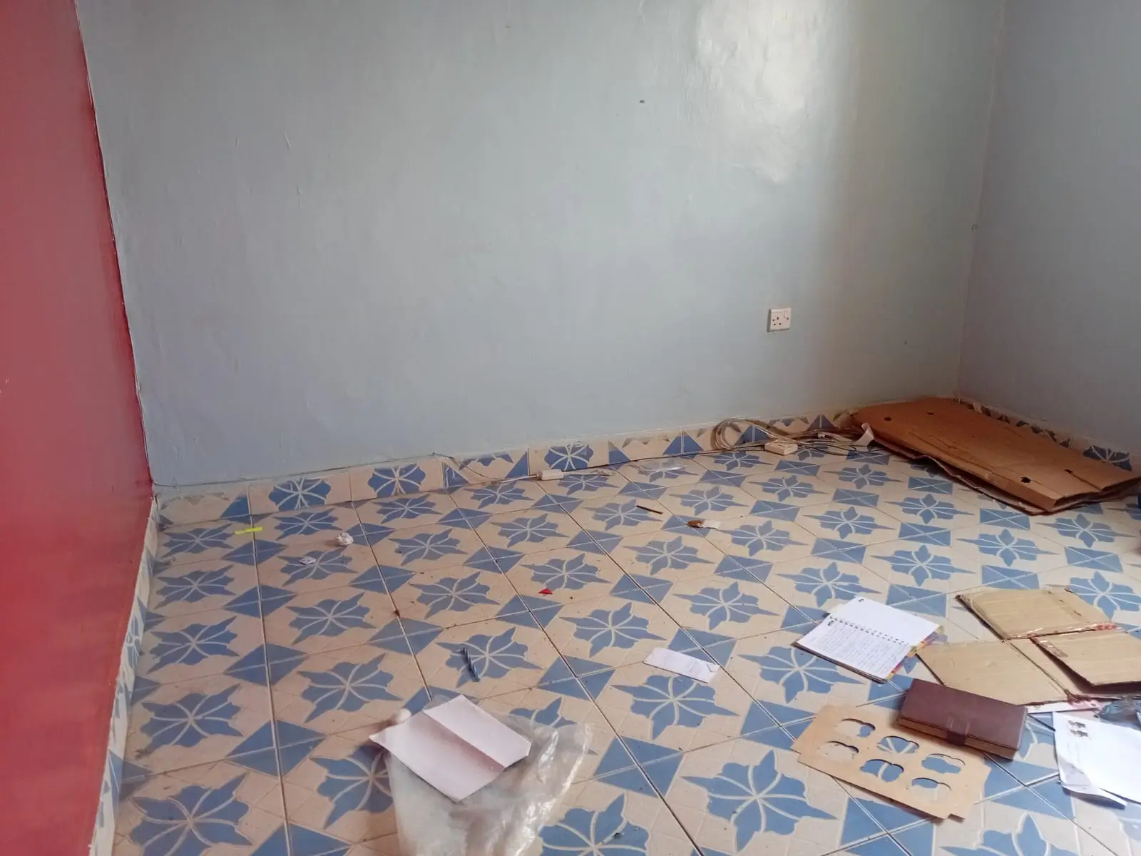 Empty bedroom with patterned tile floor, renovation in progress