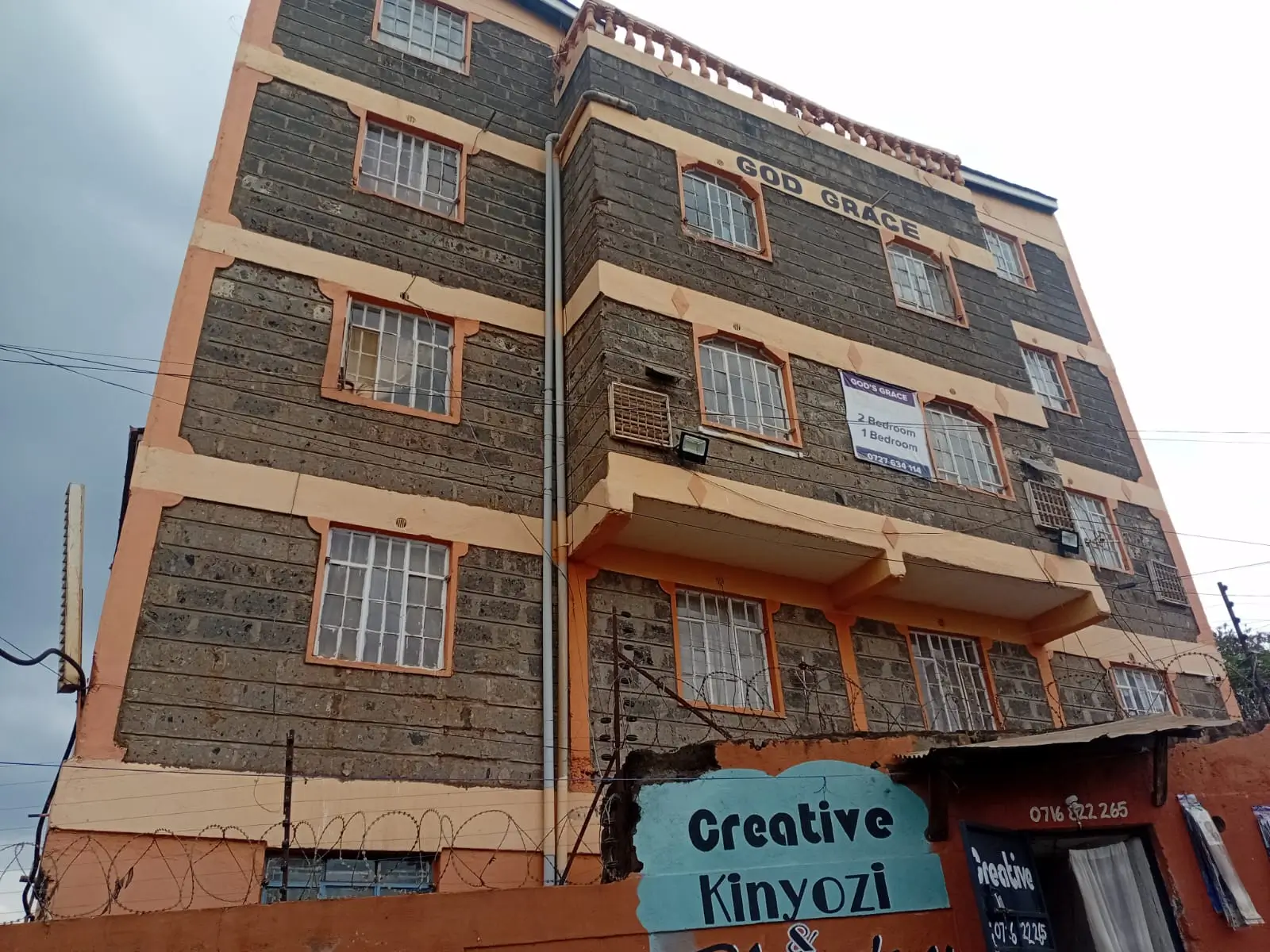 Multi-story residential building facade with stone cladding