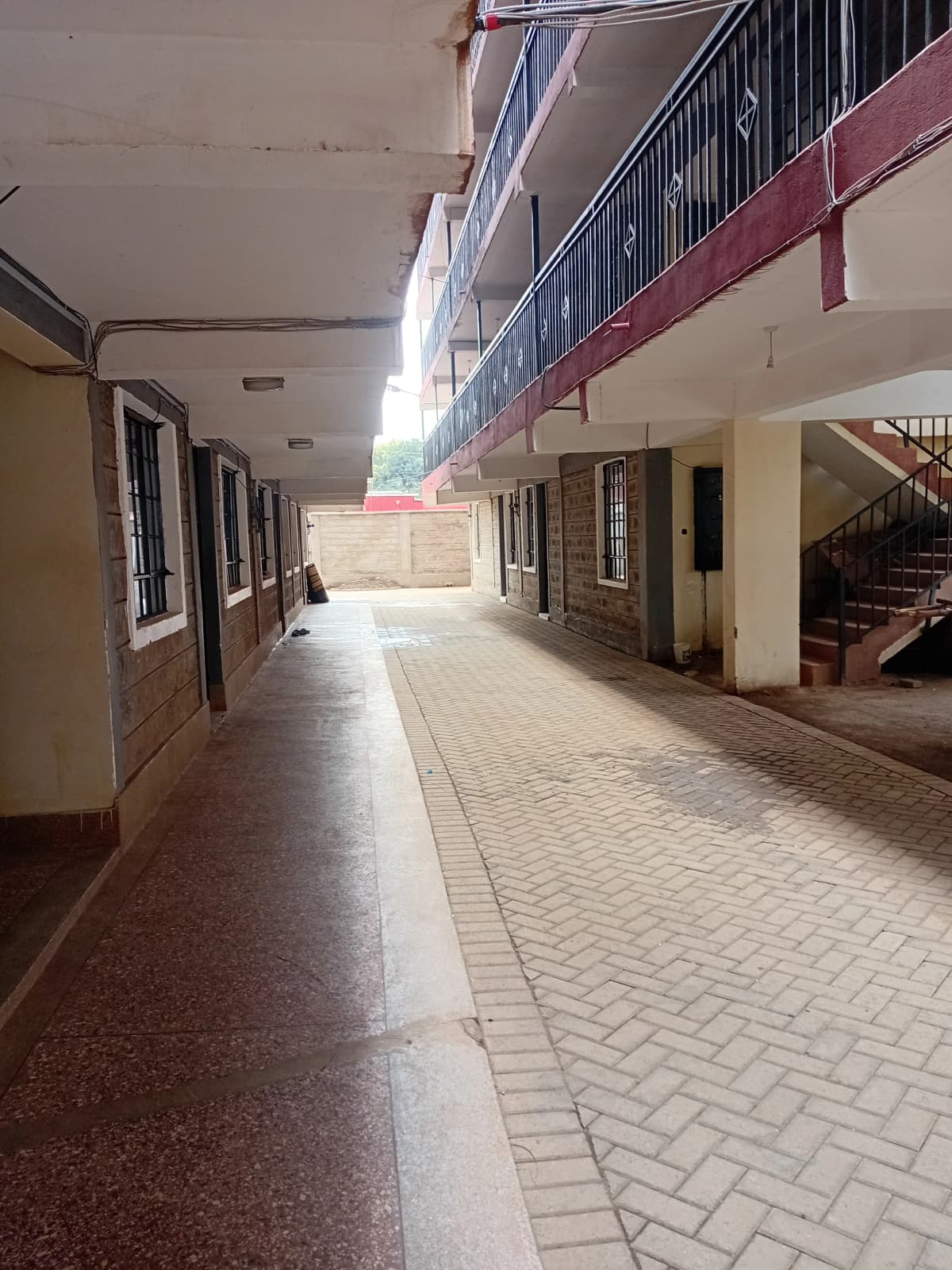 Ground floor corridor with patterned tiles and staircase
