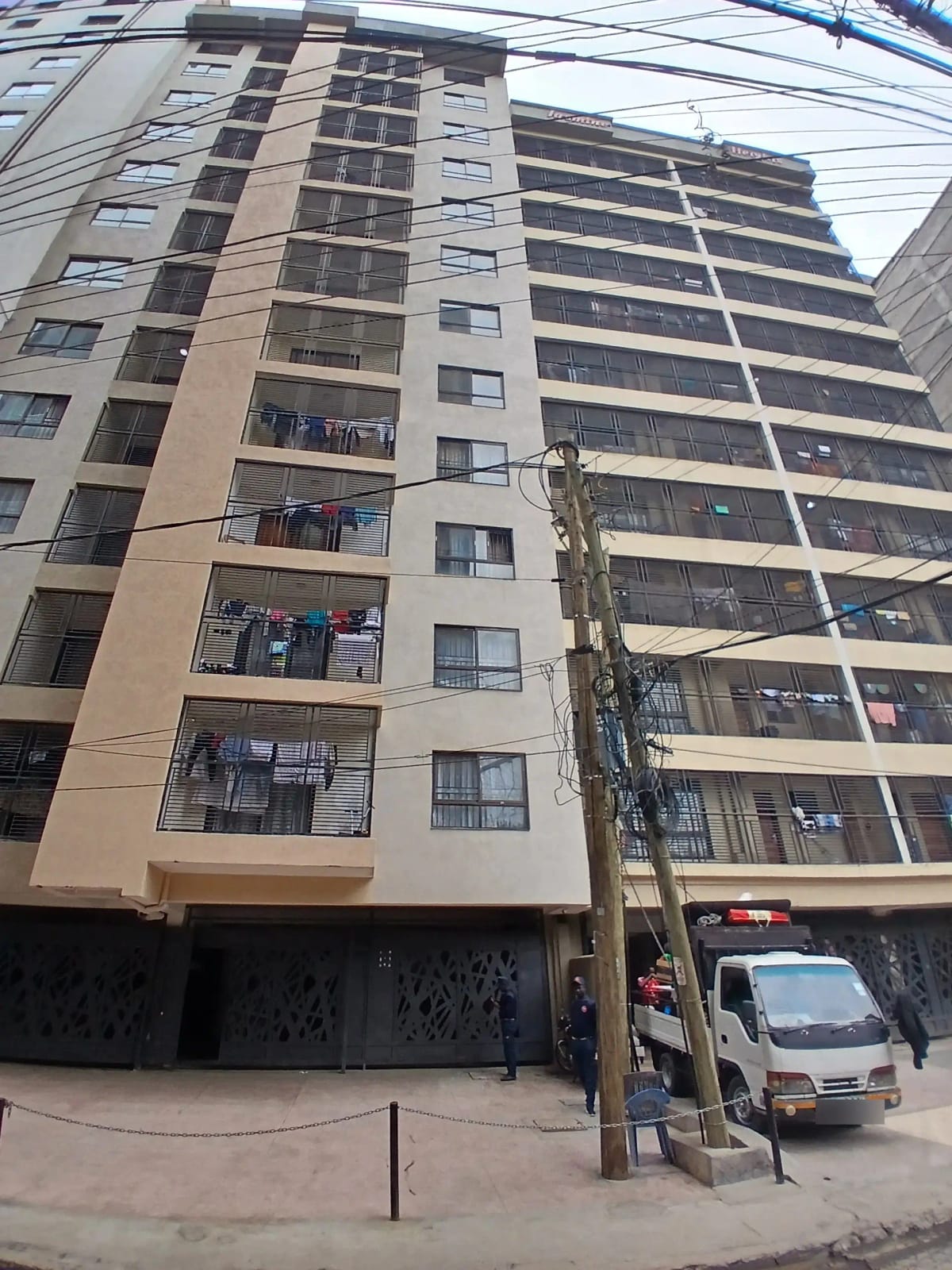 Multi-story residential building facade with ground-level parking