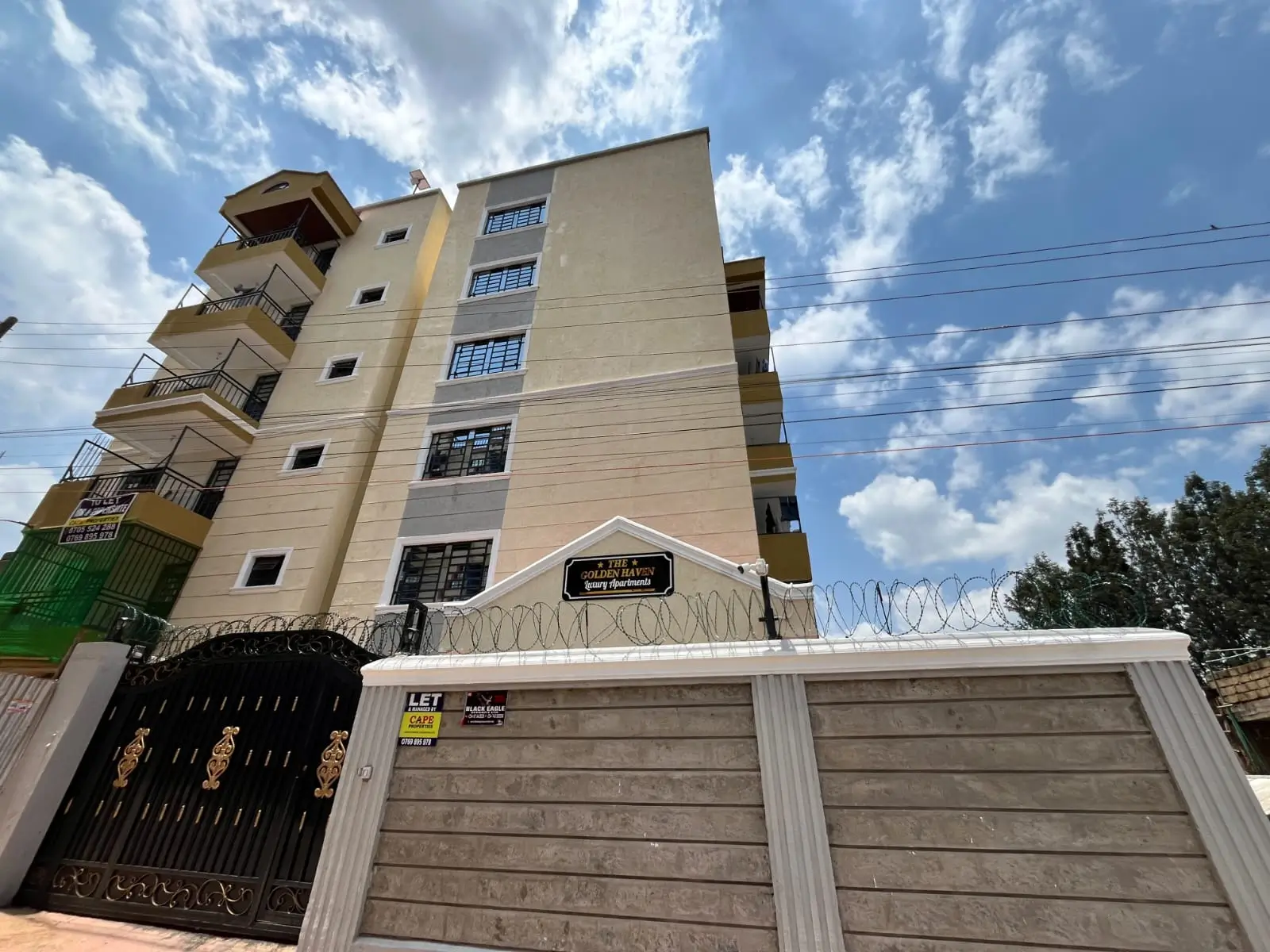 Multi-story residential building with gated compound entrance