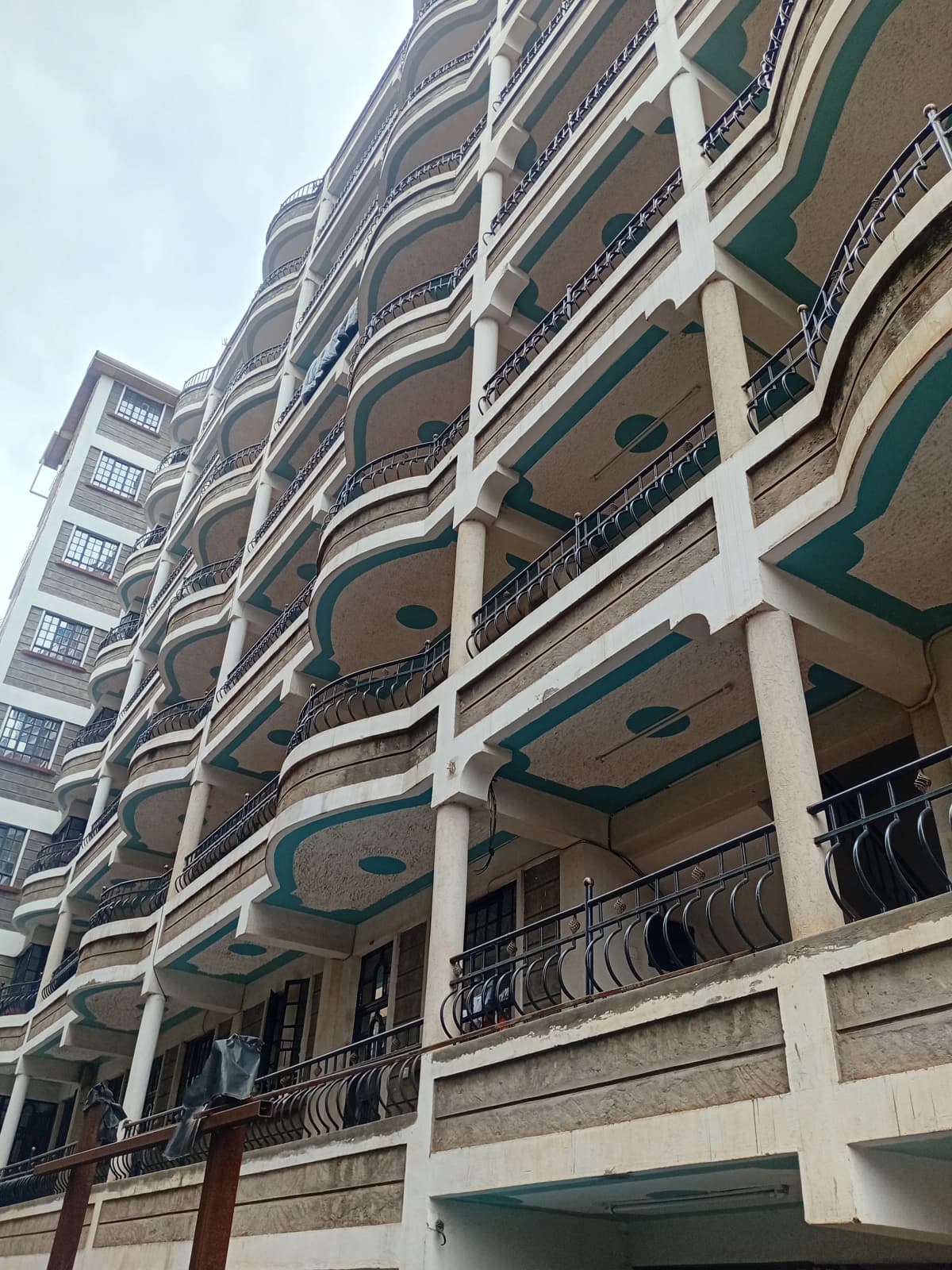 Multi-story residential building facade with curved balconies