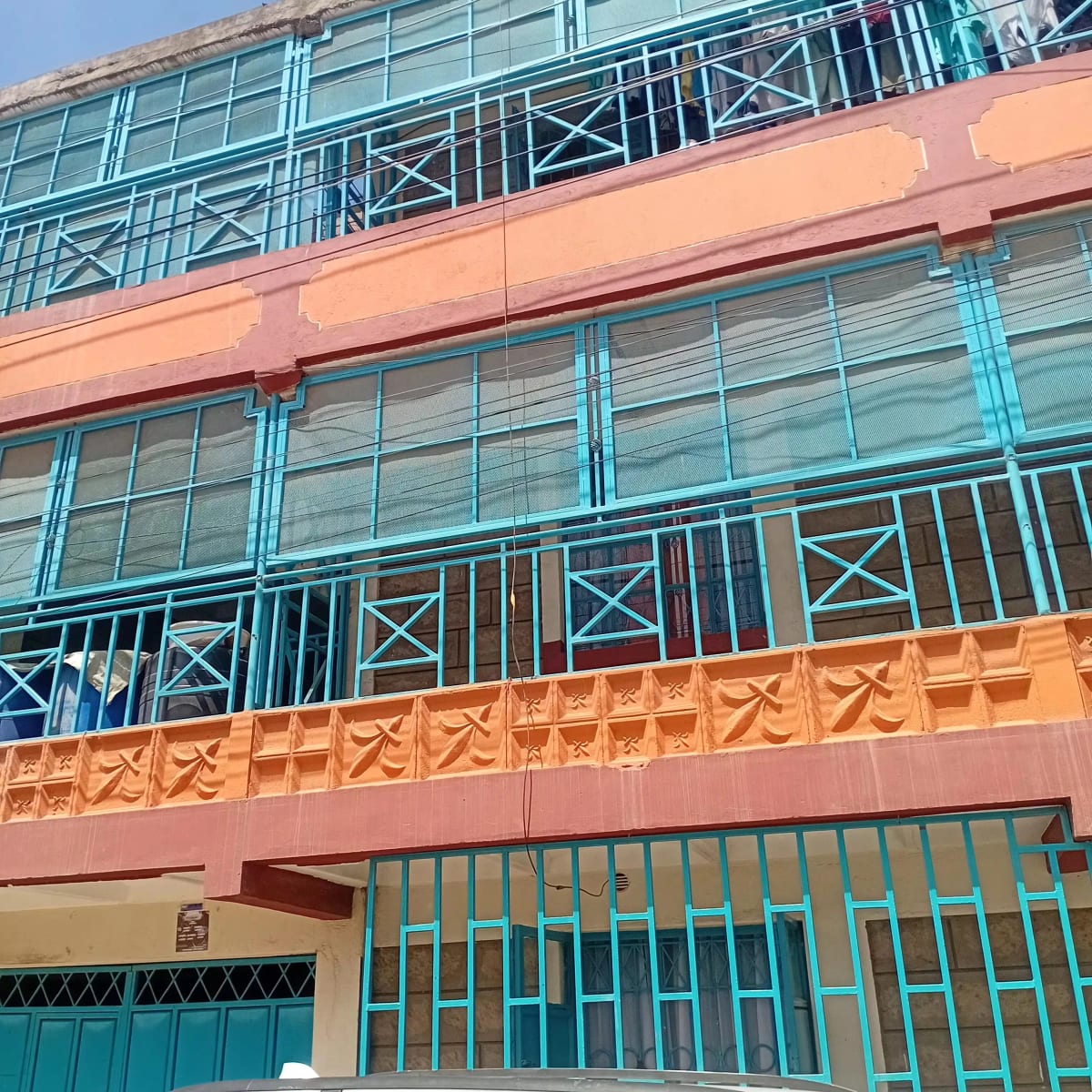 Colorful residential building facade with turquoise railings