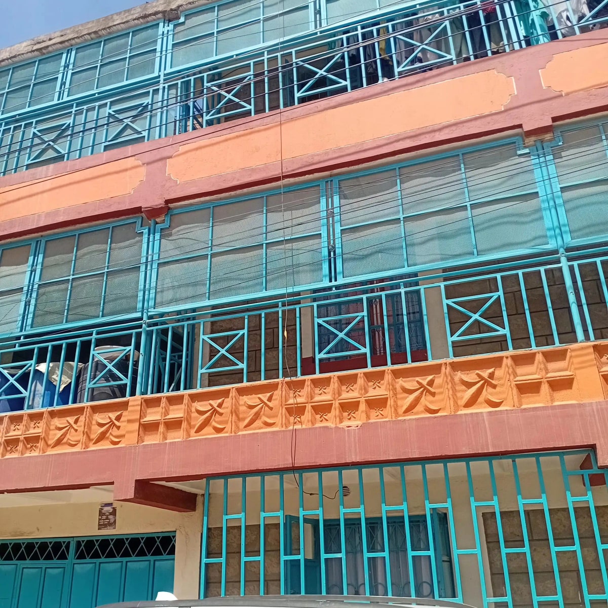 Colorful residential building facade with turquoise railings