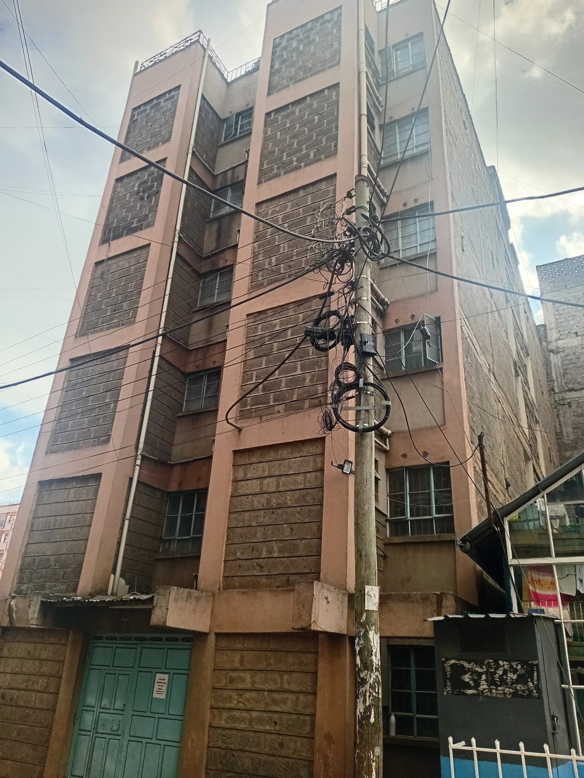 Multi-story residential building facade with brick and stone cladding