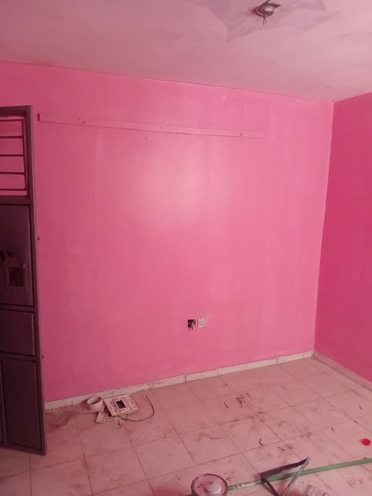 Empty bedroom with bright pink walls, under construction