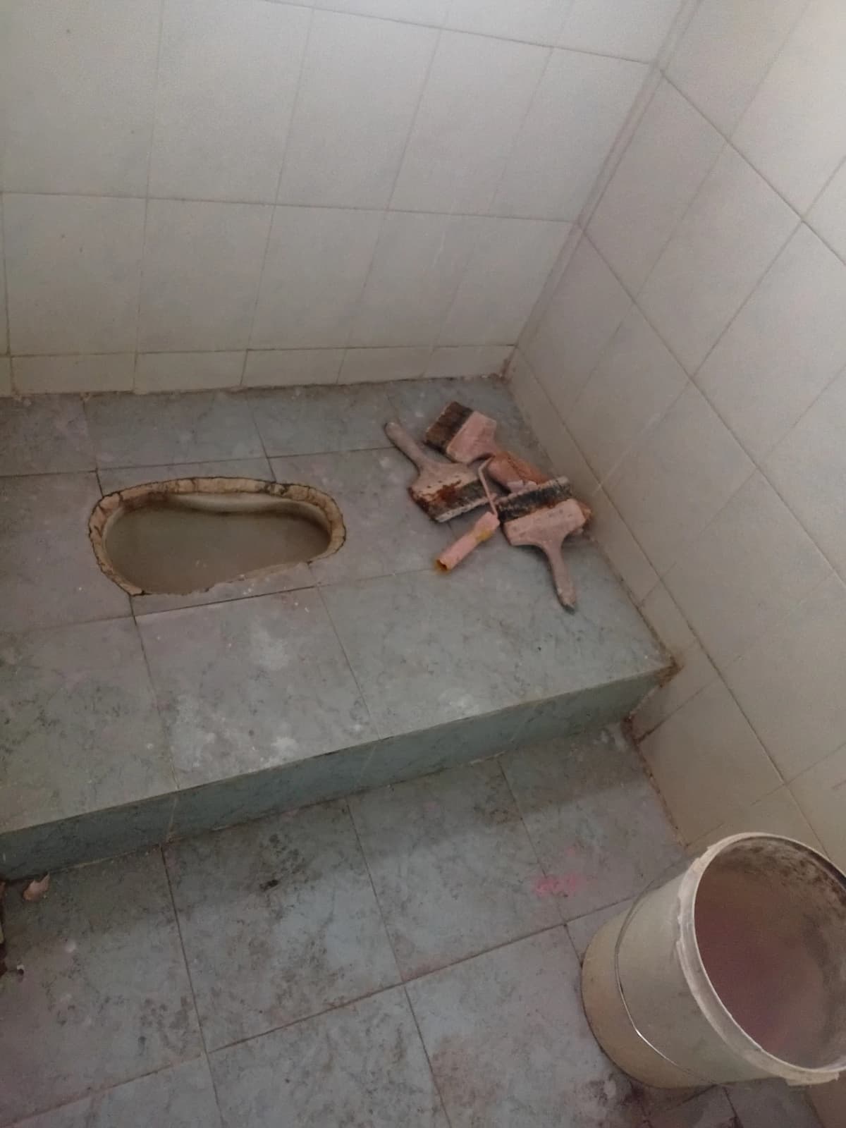 Bathroom under renovation with exposed fixtures and tiling