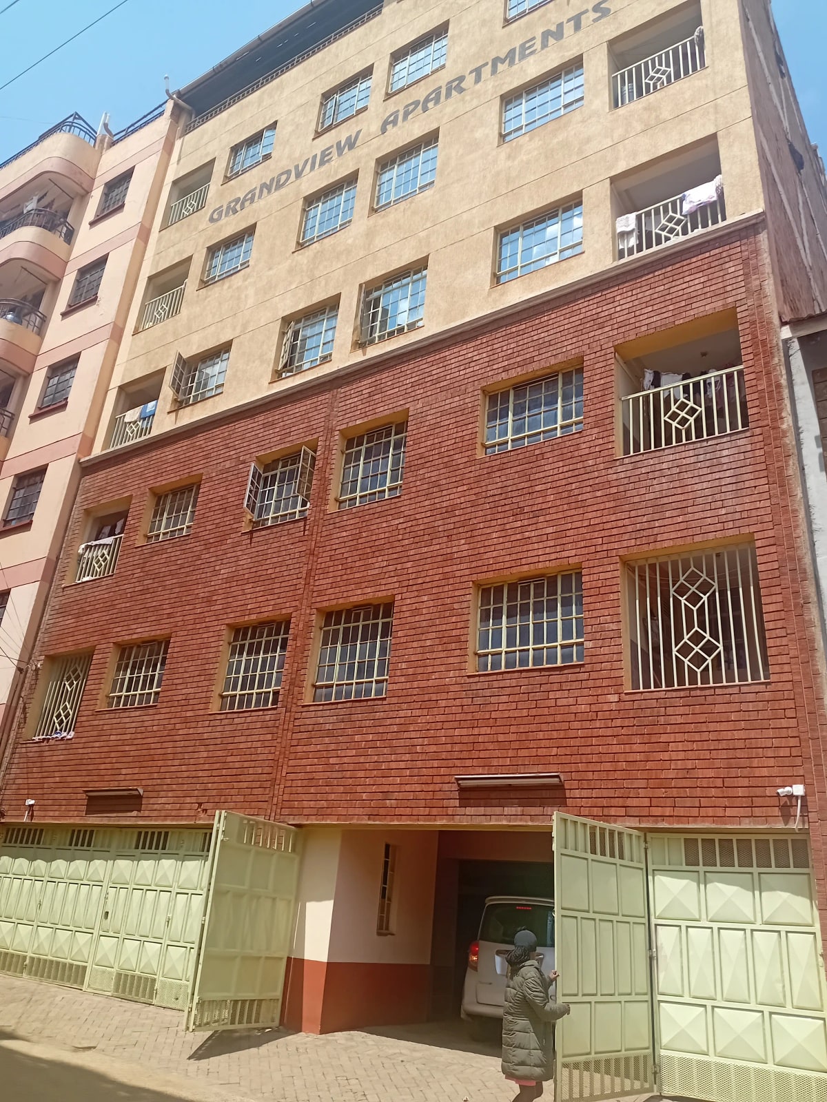 Multi-story residential building with brick and plastered facade