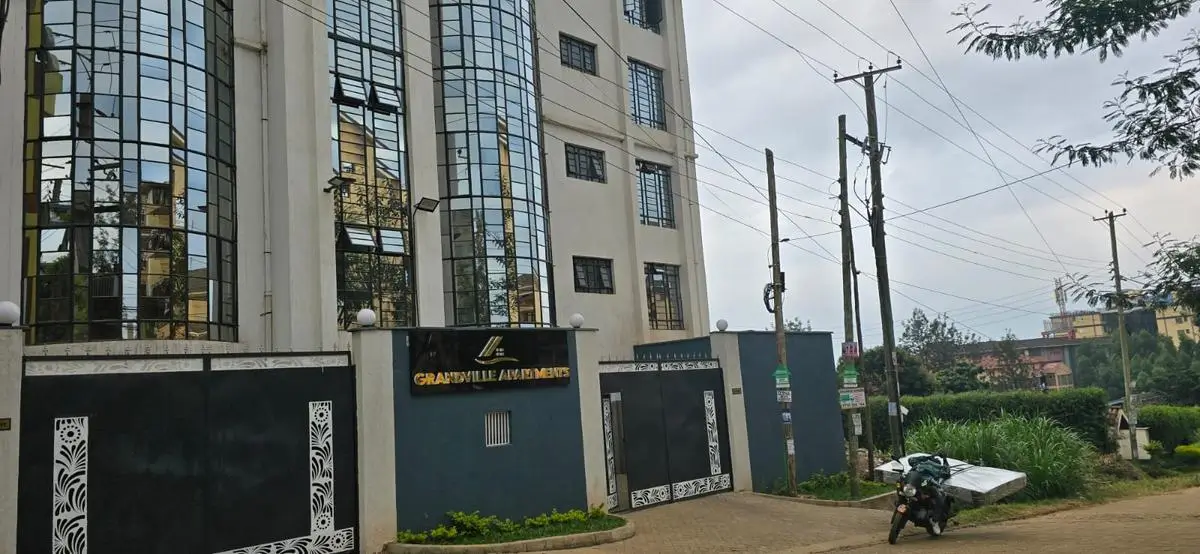 Modern multi-story residential building with gated entrance