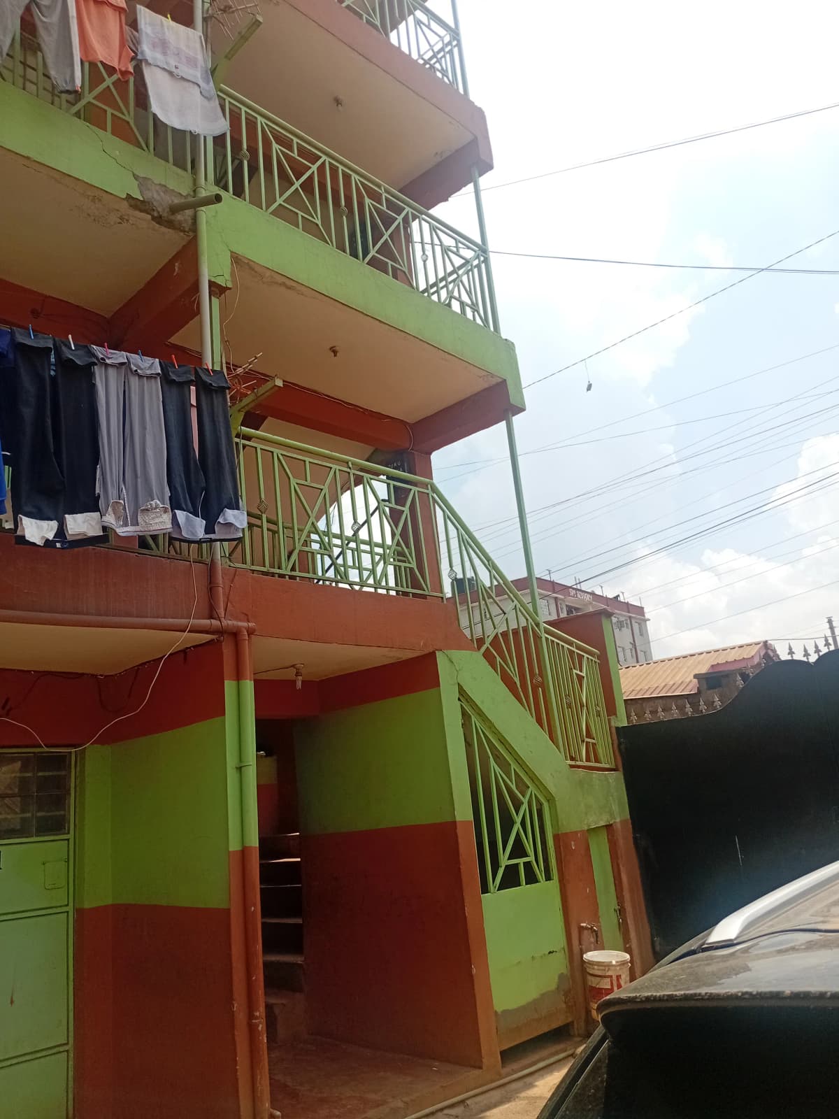 Multi-story apartment building with green and red facade