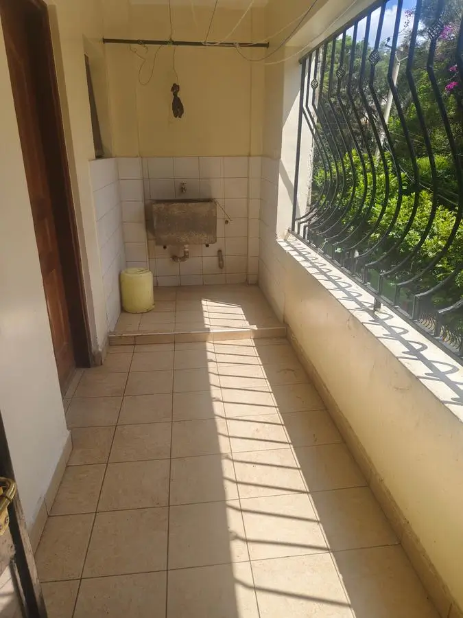Narrow utility room with sink and bright natural light from window