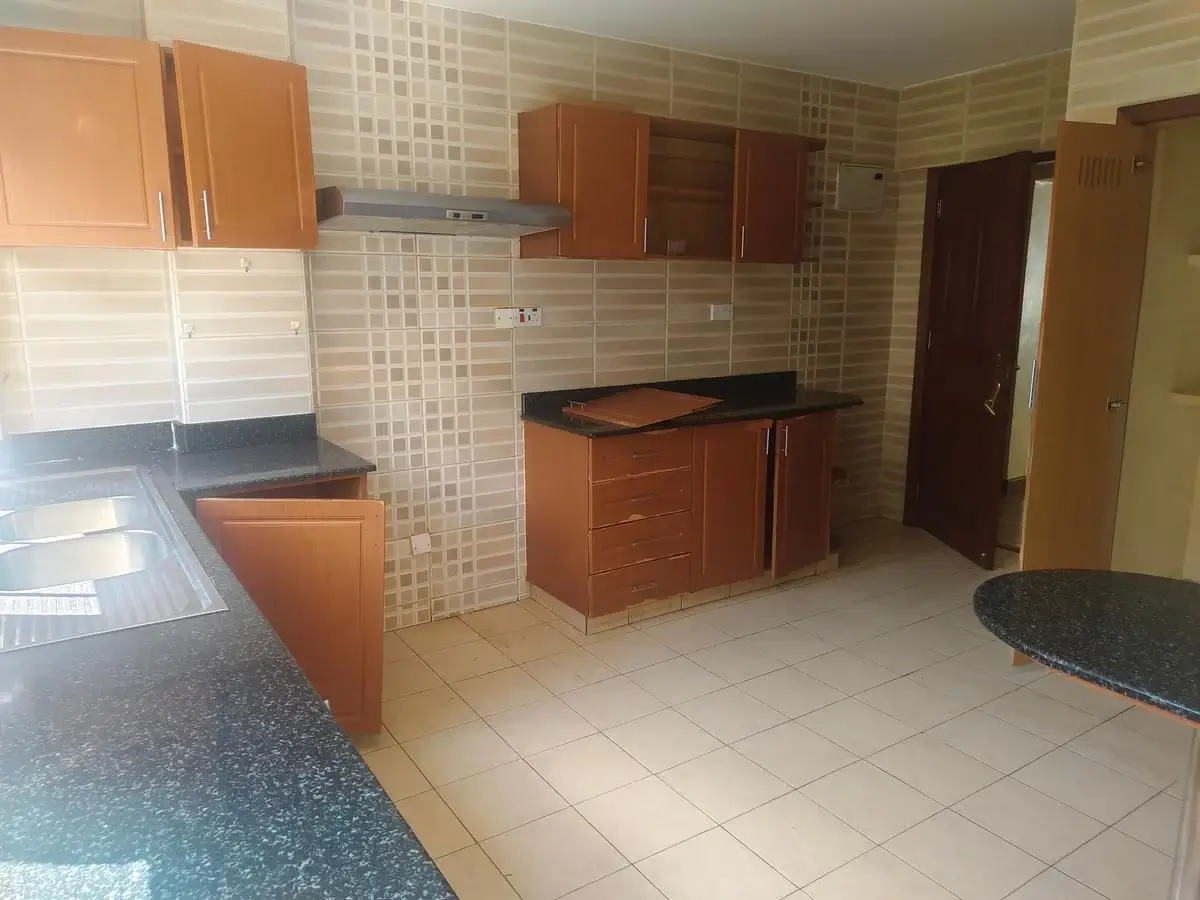 Open-plan kitchen with wooden cabinets and tiled backsplash