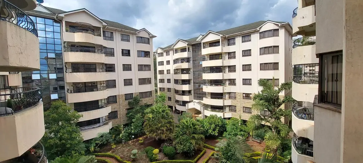Multi-story residential complex with manicured central courtyard garden