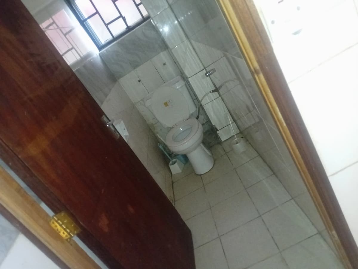 Basic bathroom with toilet and tiled flooring