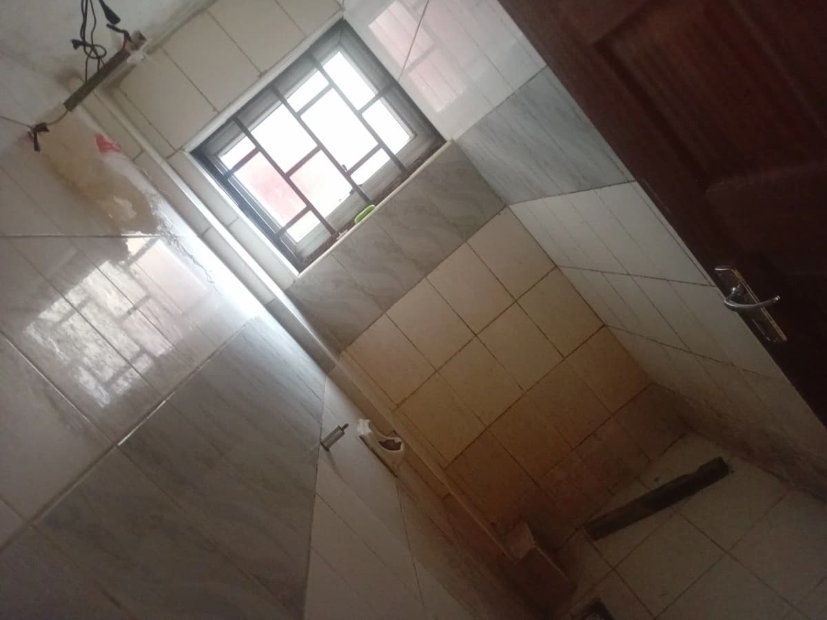 Basic bathroom with tiled walls and skylight window