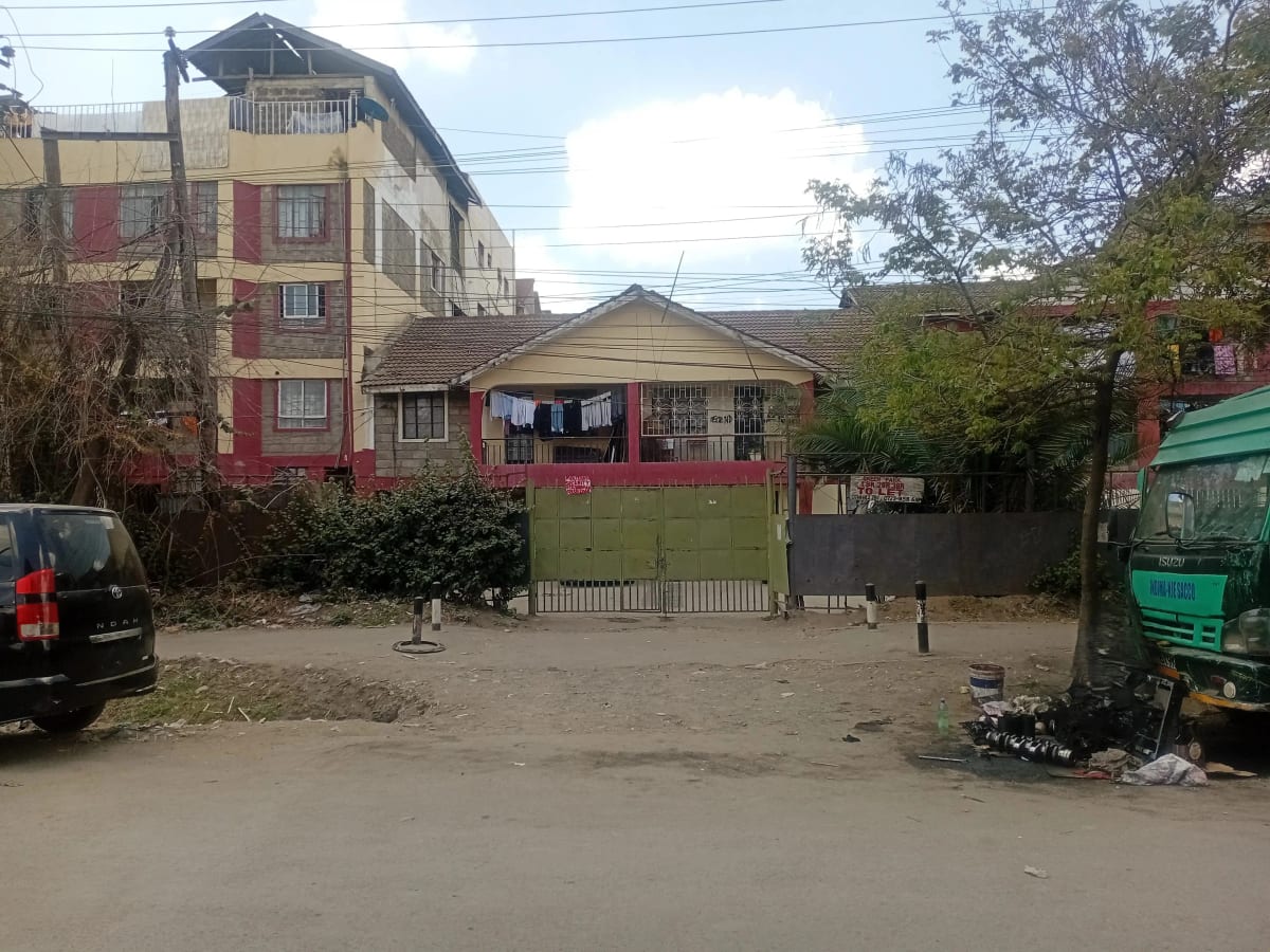 Multi-story residential building with compound entrance and gate