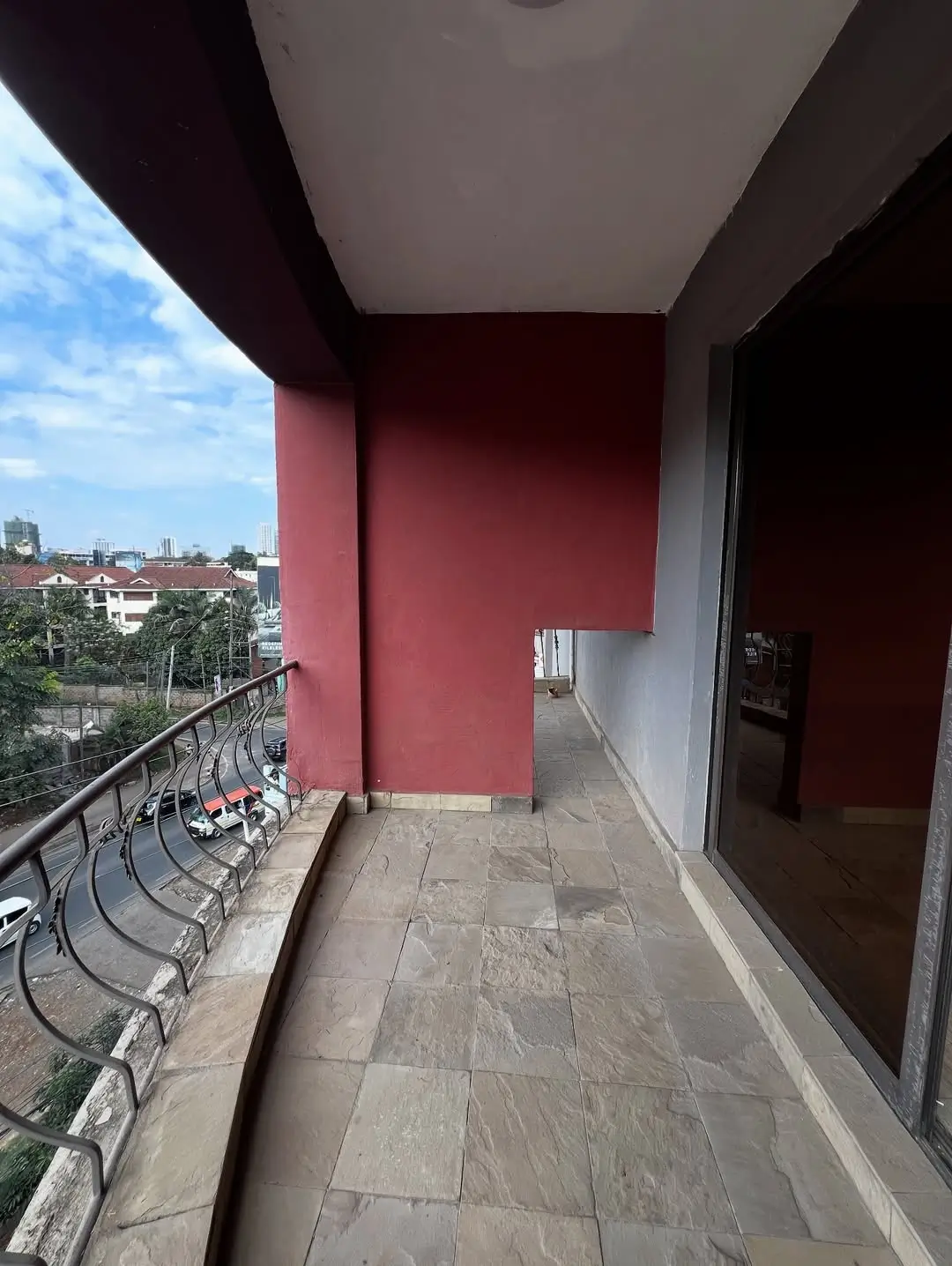 Spacious balcony with city skyline views and modern railing