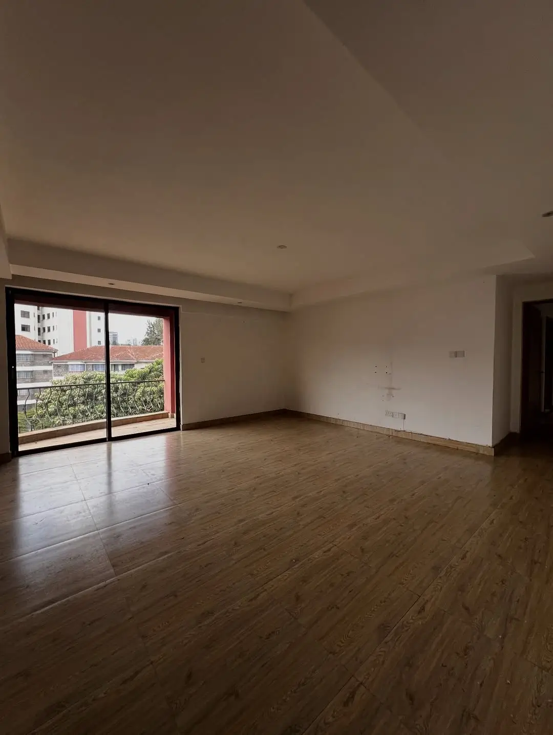 Spacious living room with sliding glass doors and city view