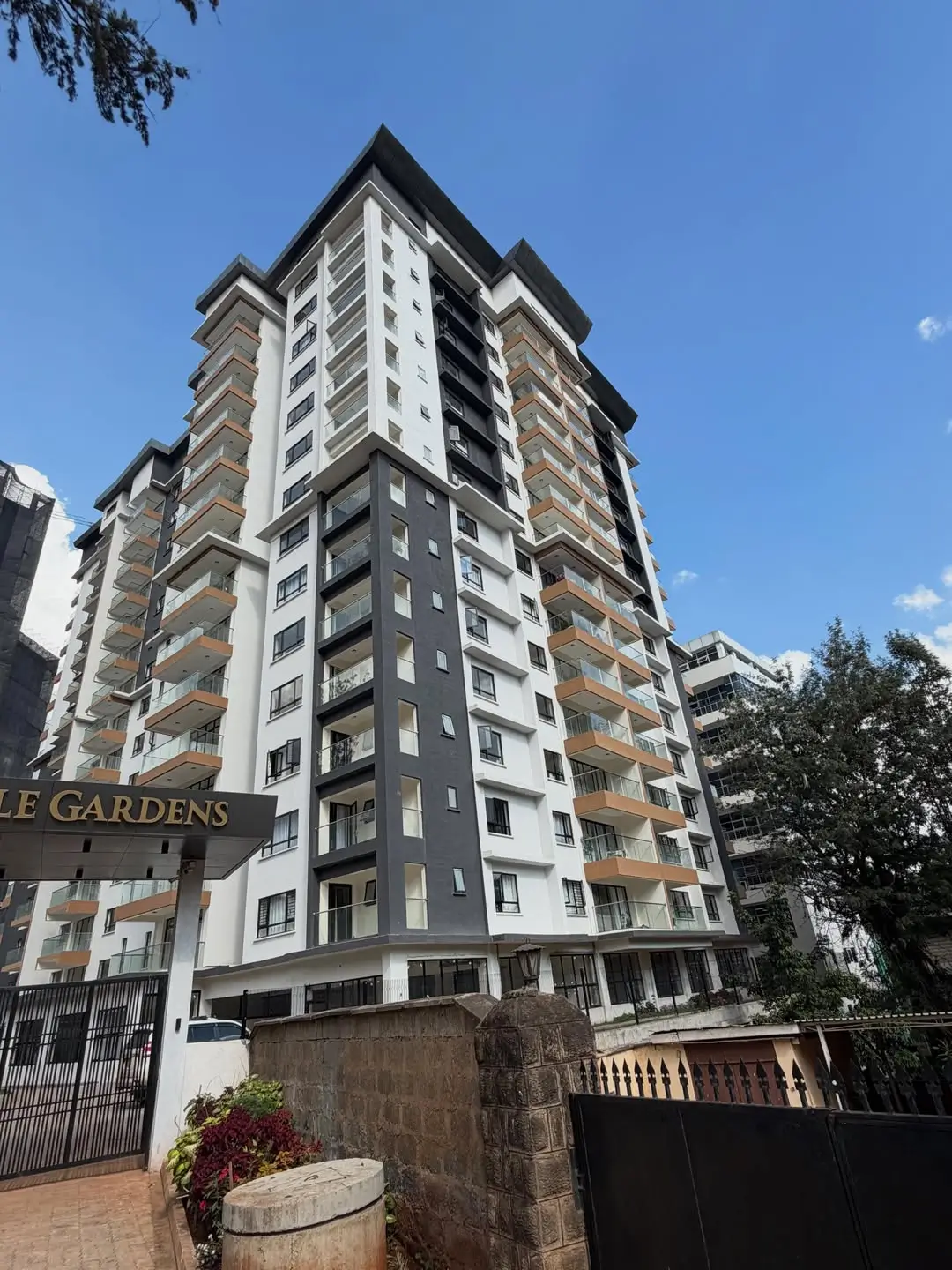 Modern multi-story residential building with mixed facade materials