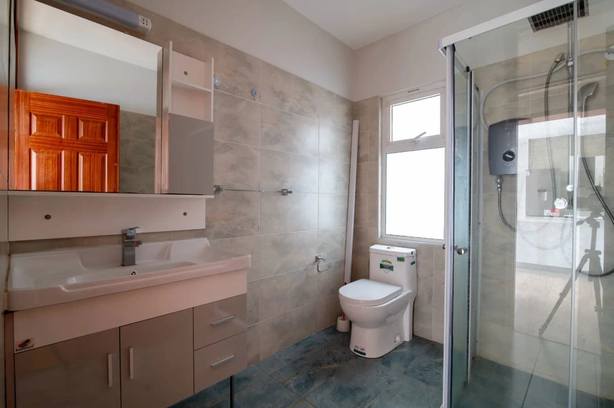Modern bathroom with vanity, toilet, and glass shower enclosure