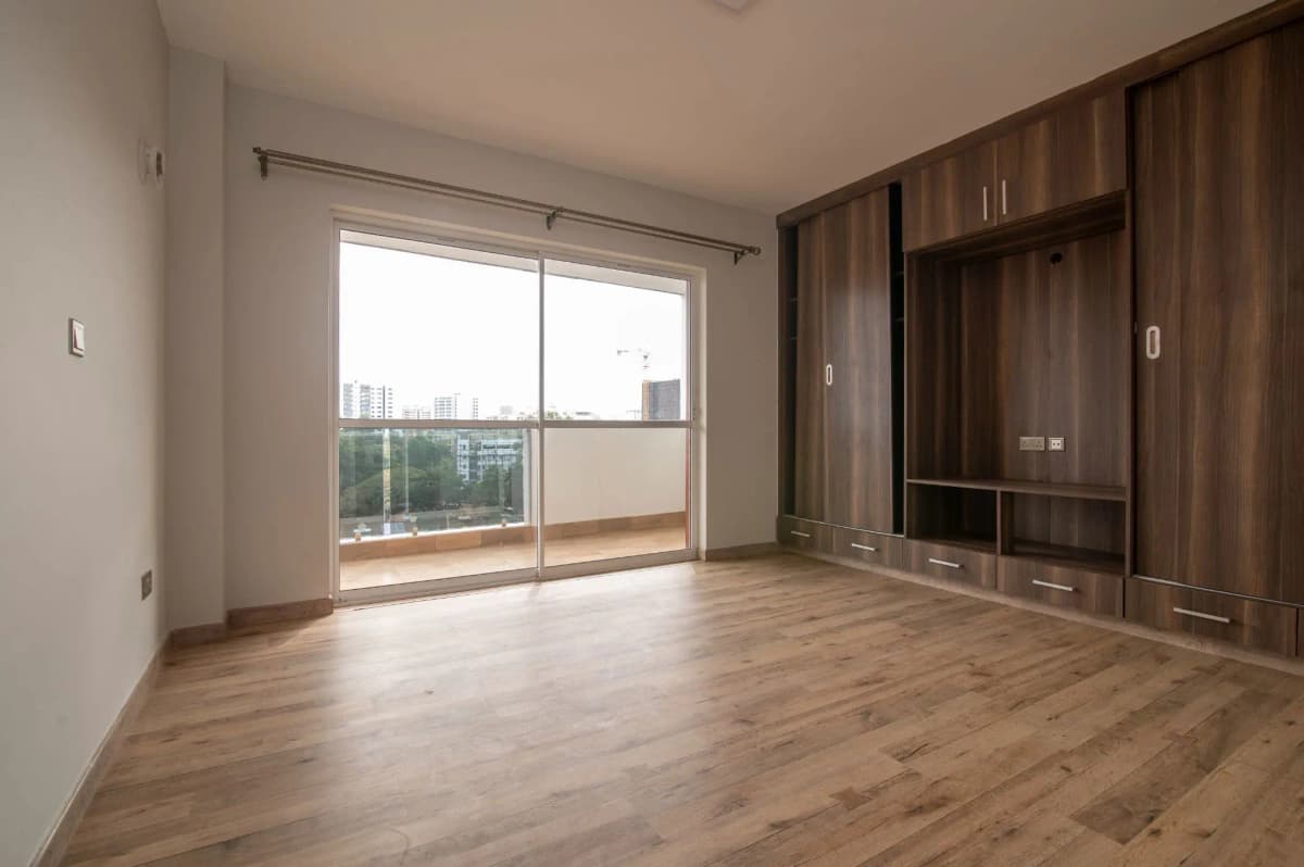 Spacious living room with built-in wooden cabinetry, city views