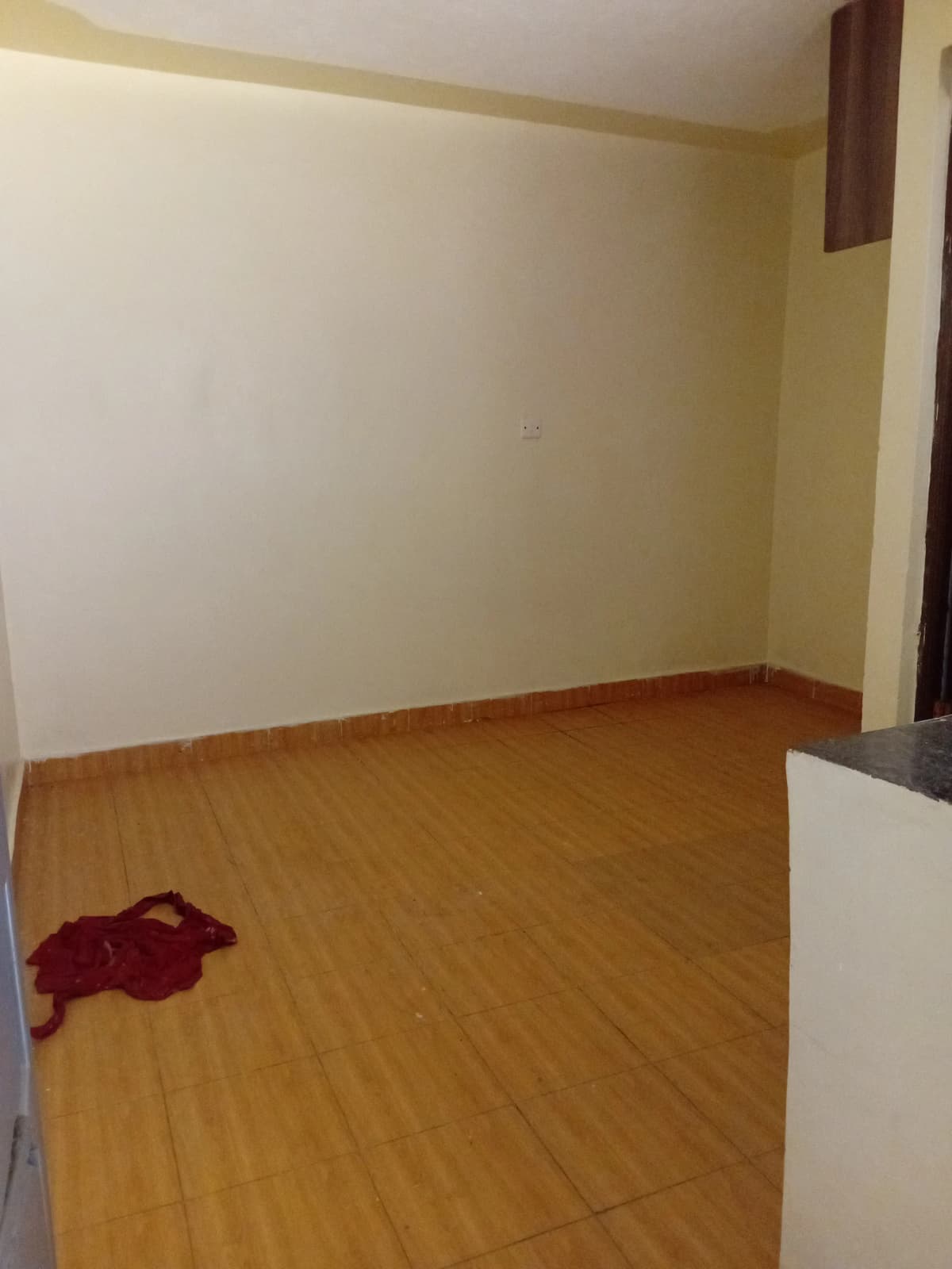 Empty bedroom with wooden floor and neutral walls