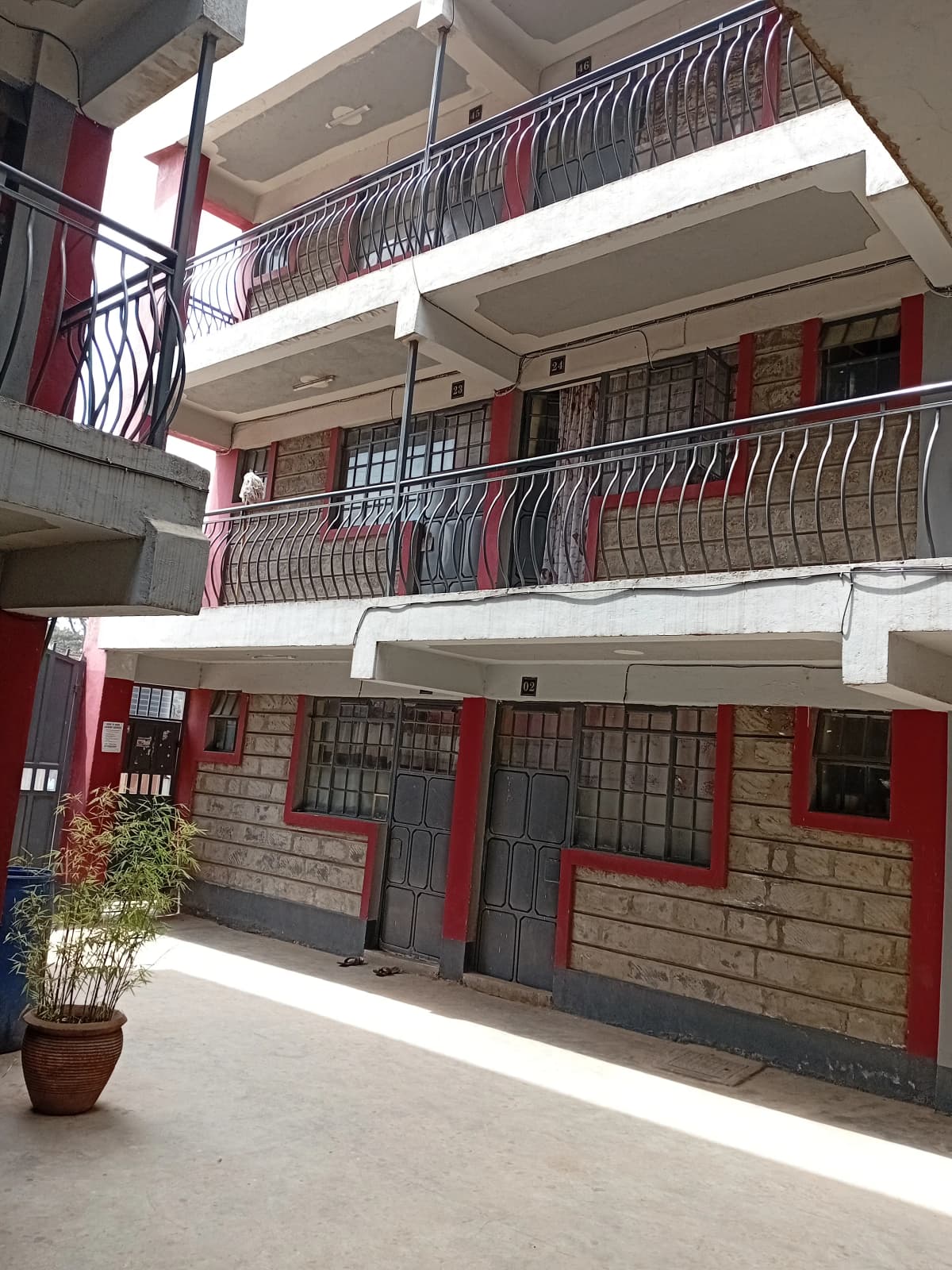 Multi-story residential building with red doors and balconies