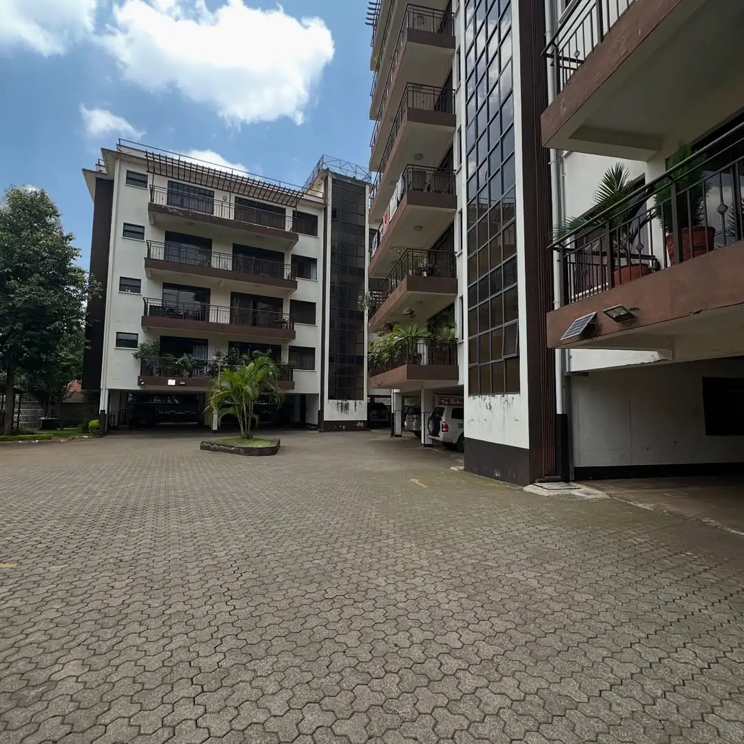 Multi-story residential compound with paved courtyard entrance