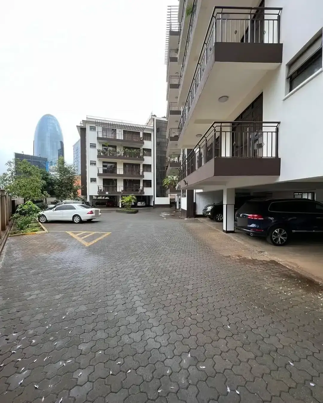 Ground-level parking area with residential building facade