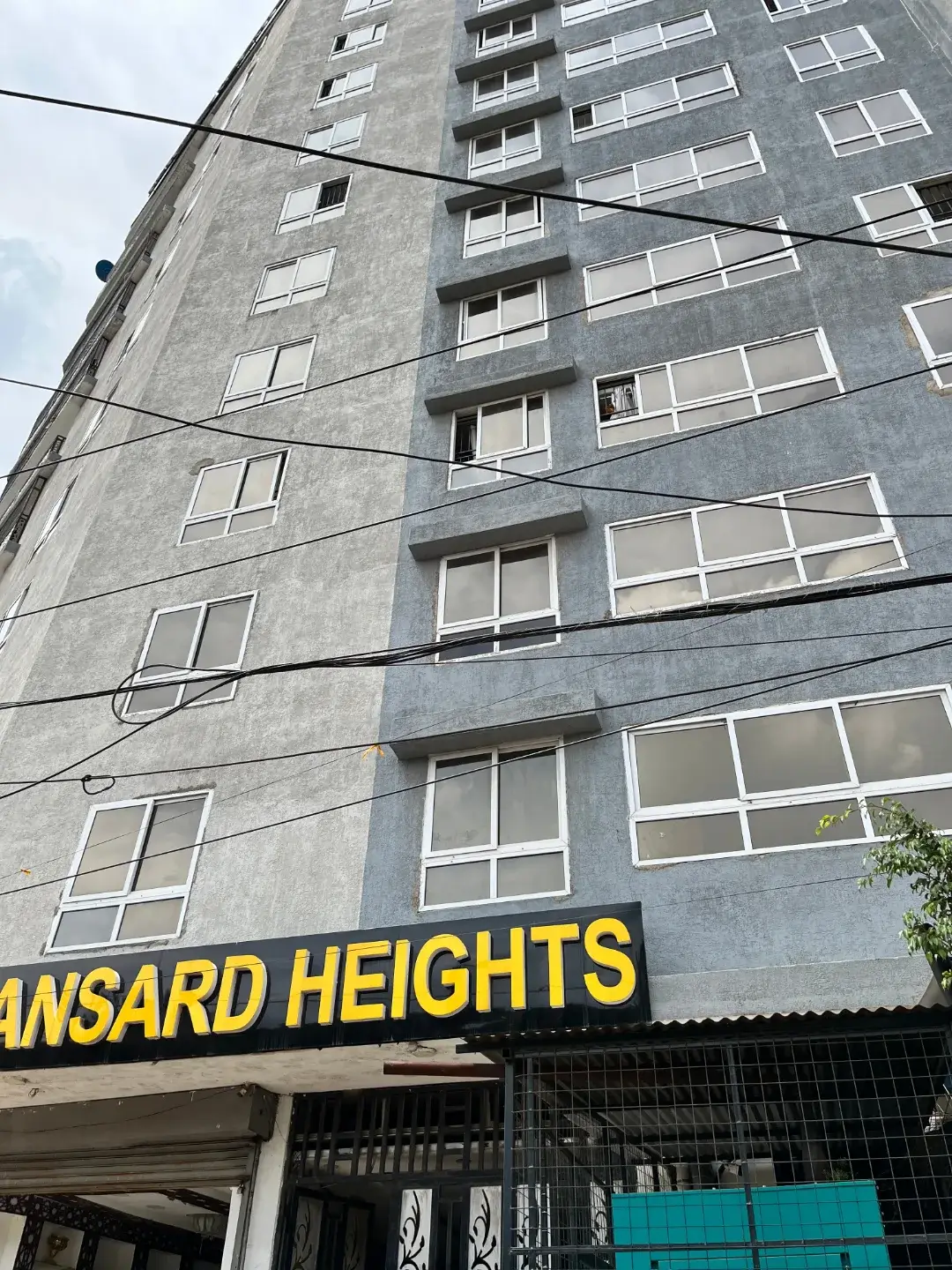 Multi-story residential building facade with grid of windows