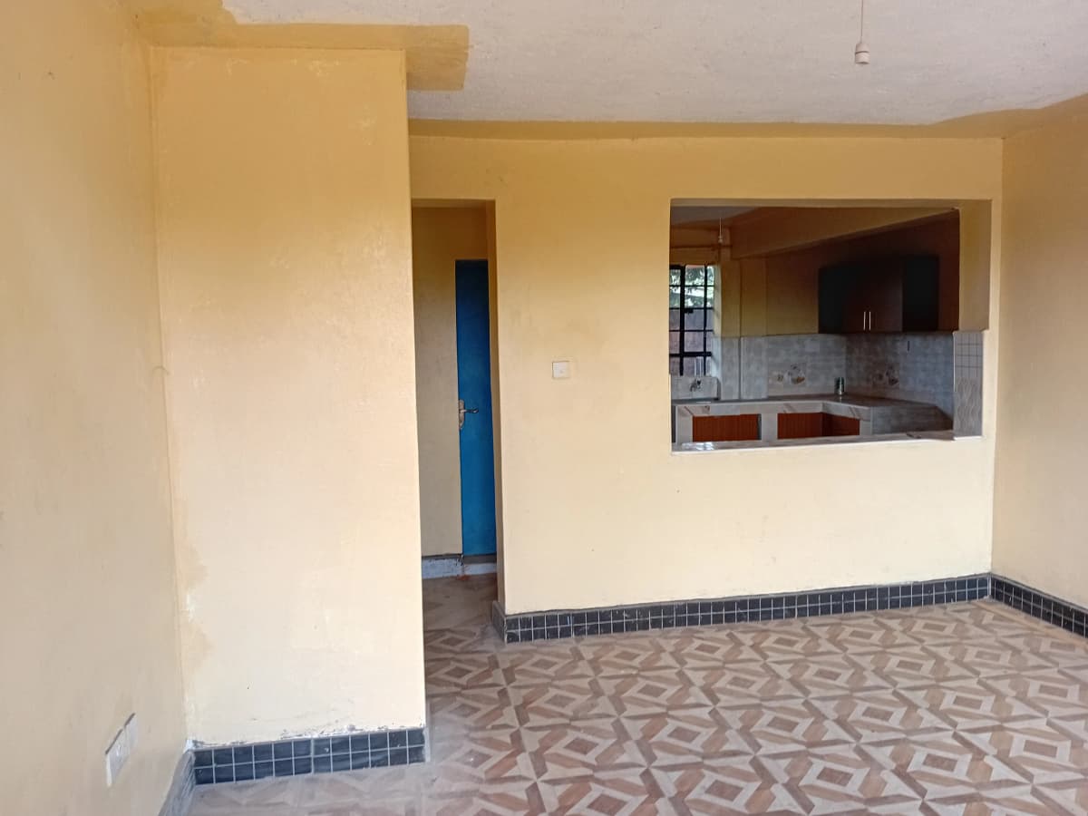 Open-plan living room with visible kitchen pass-through window