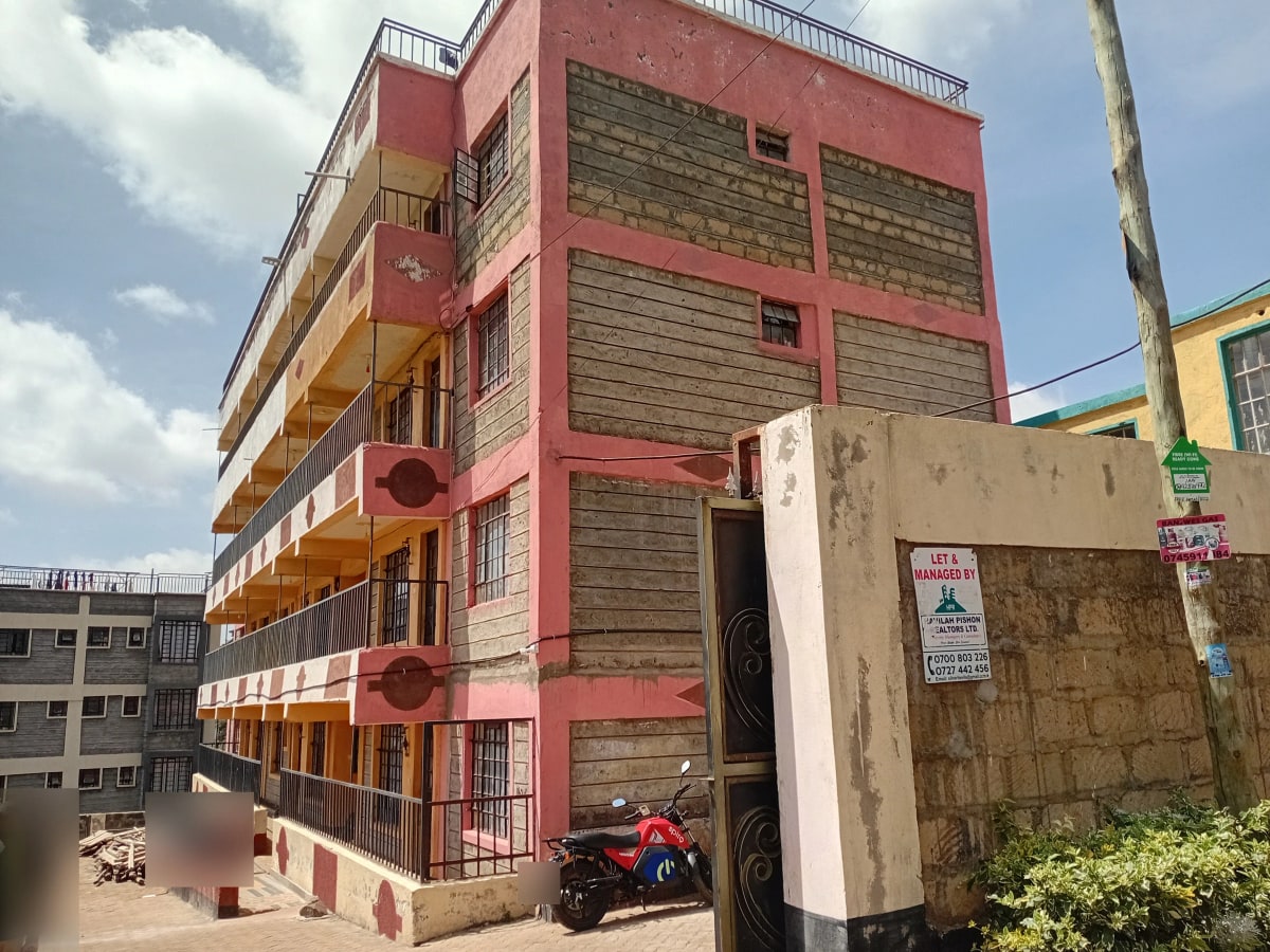 Multi-story residential building with red and yellow facade