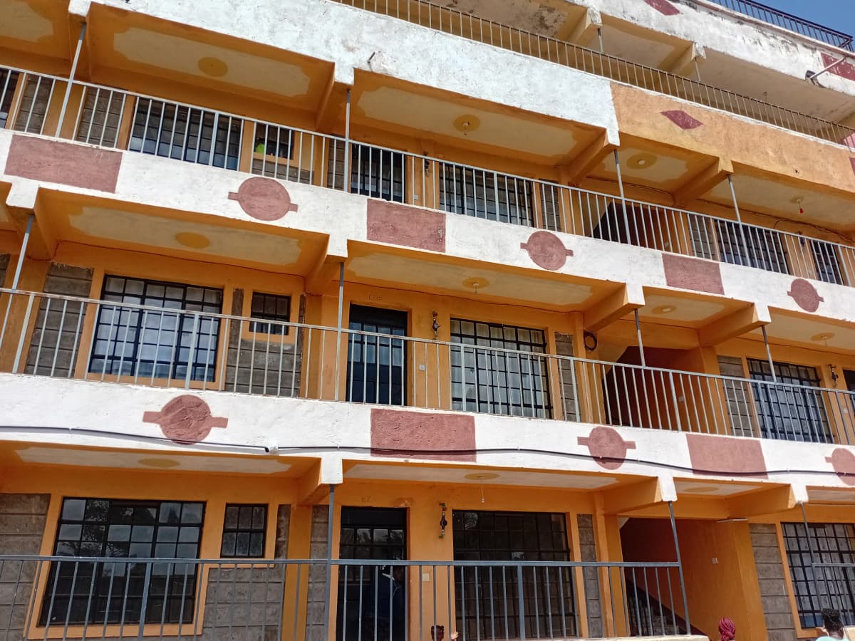 Multi-story residential building facade with balconies and metal railings