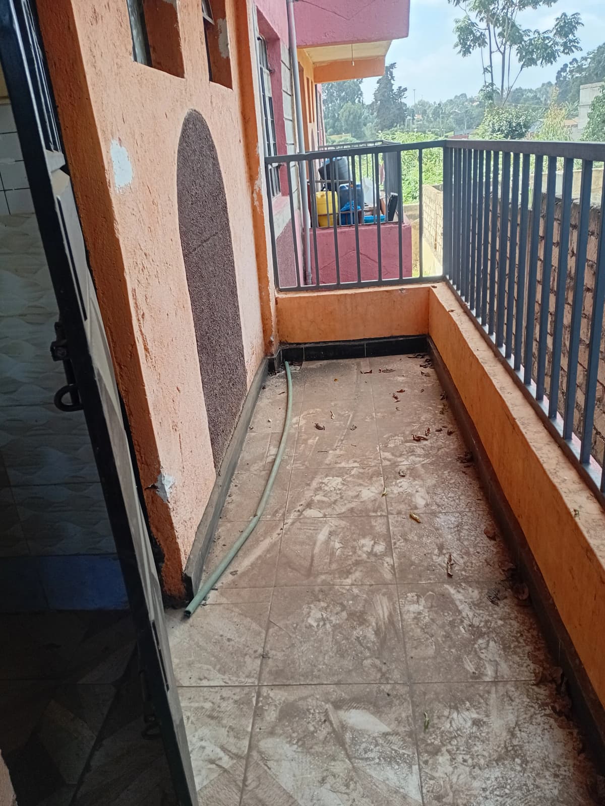 Narrow balcony with railing, green surroundings view