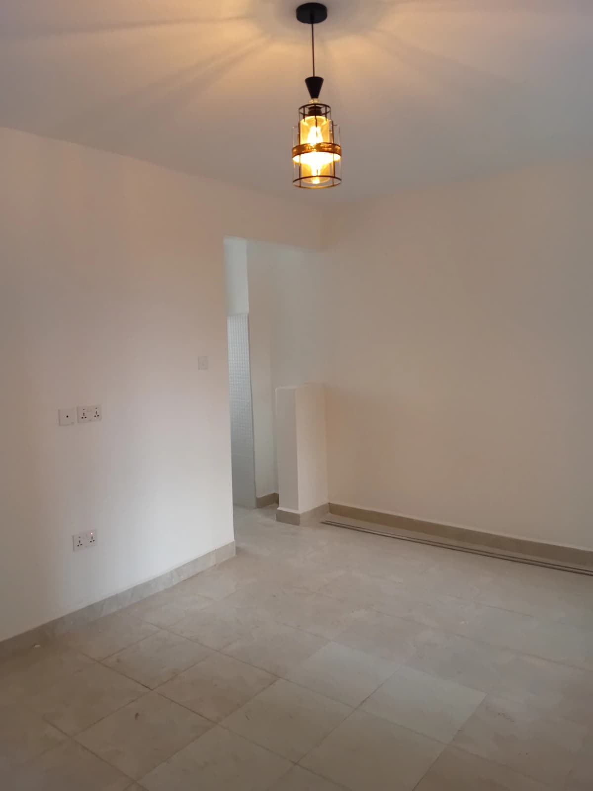 Minimalist bedroom with pendant lighting and tiled flooring