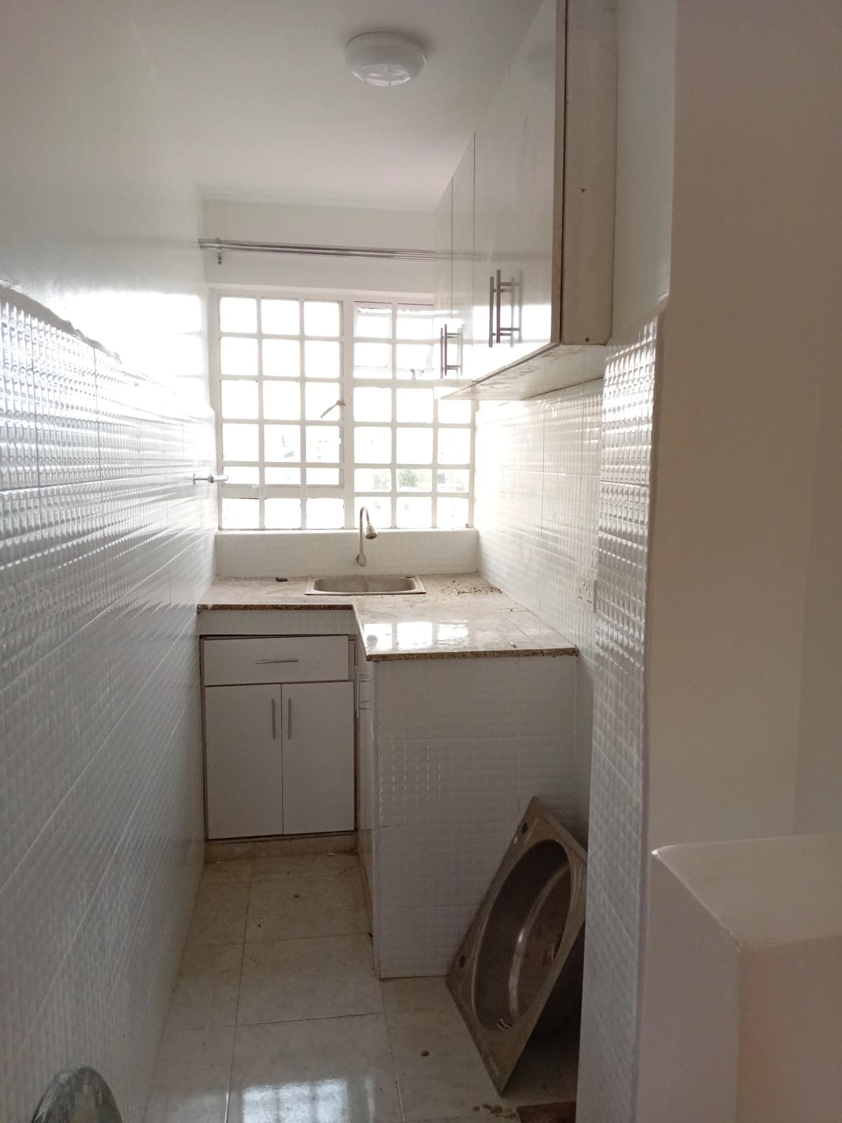 Compact laundry room with washing machine and utility sink