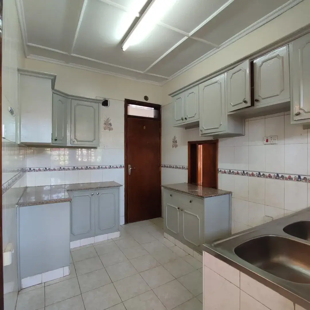 Spacious kitchen with gray cabinetry and stainless steel sink