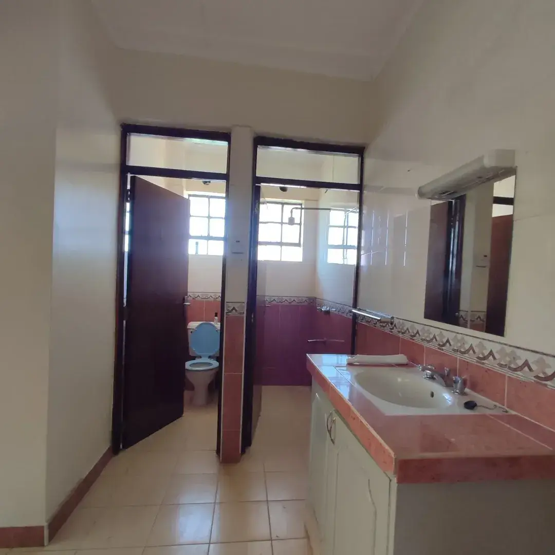 Spacious bathroom with dual vanity and separate toilet cubicle