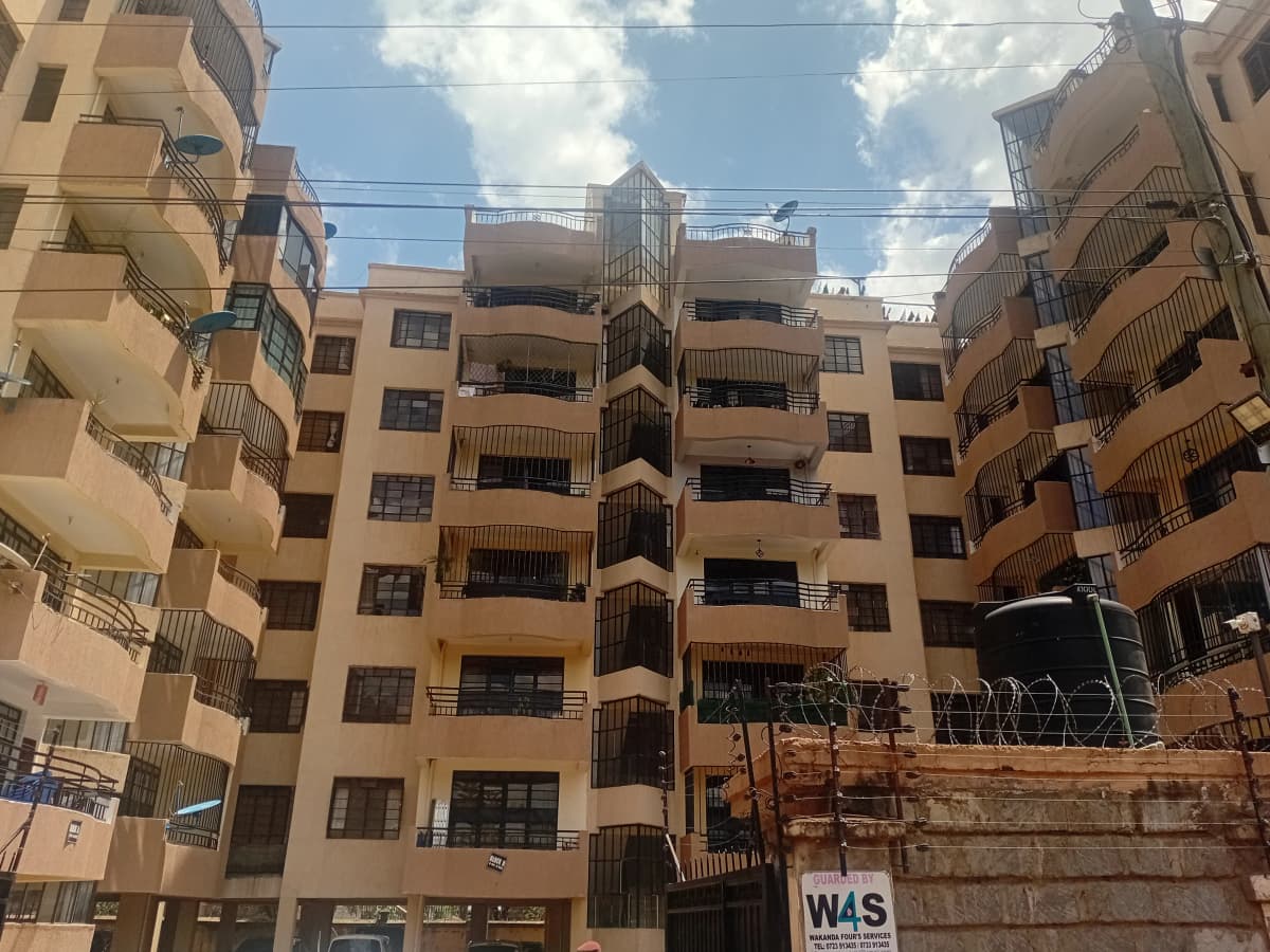 Multi-story residential building facade with balconies and windows