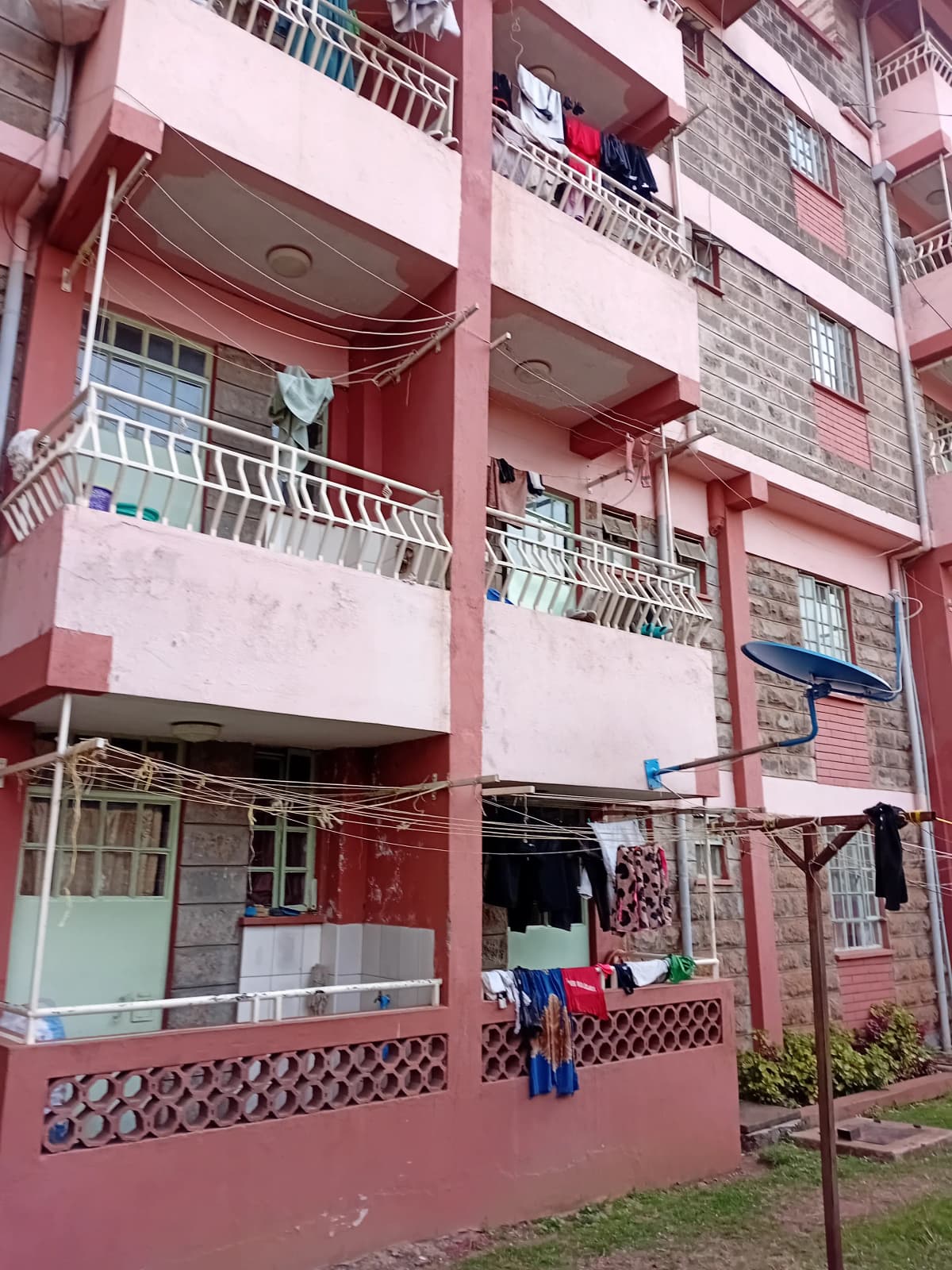 Pink residential building facade with multiple balconies