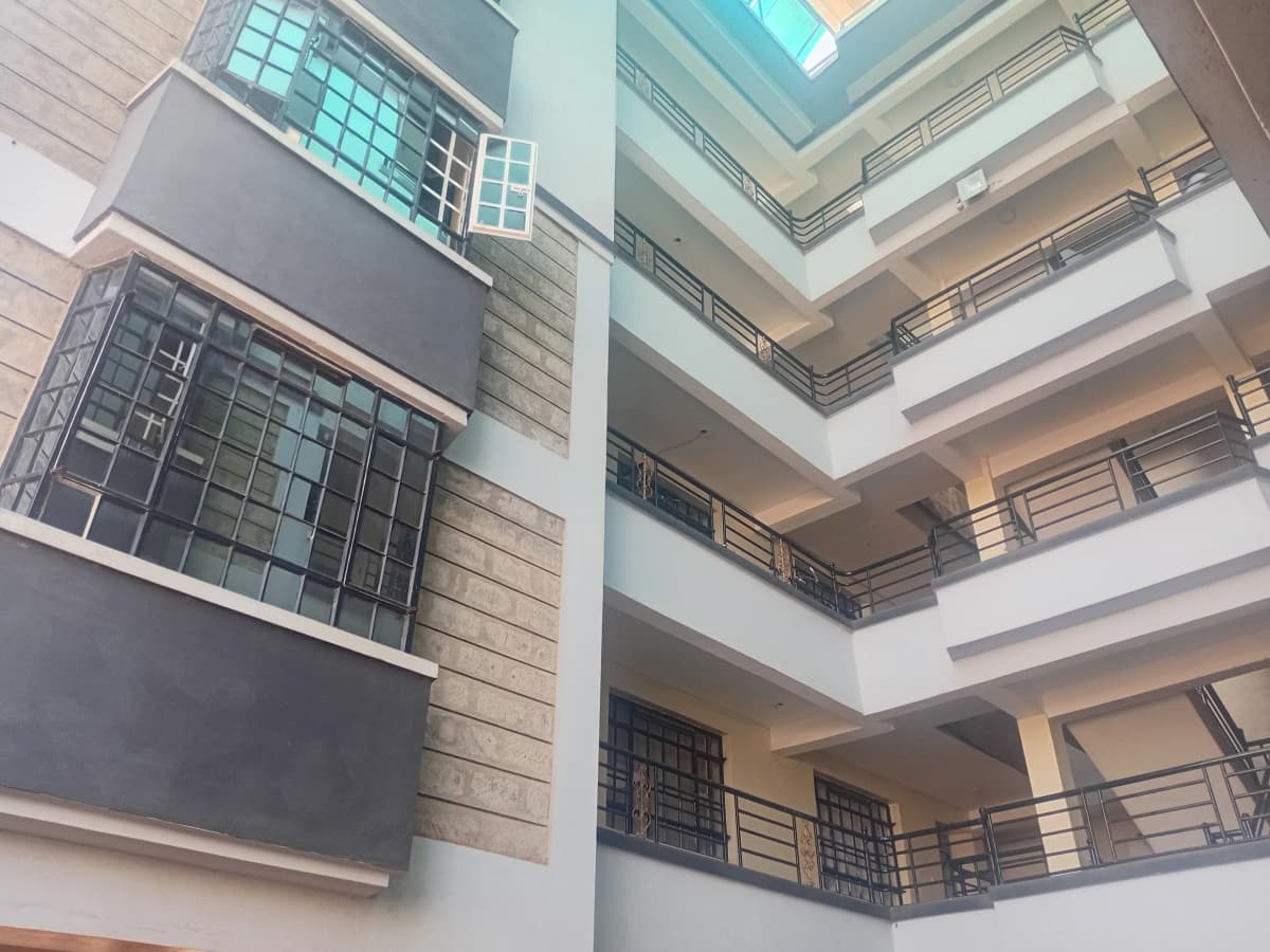 Multi-story atrium with skylight and metal railings