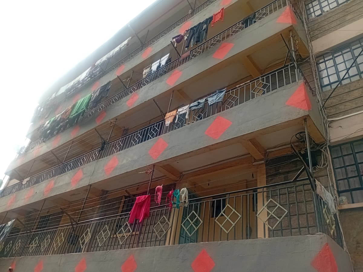 Multi-story residential building facade with balconies and clotheslines