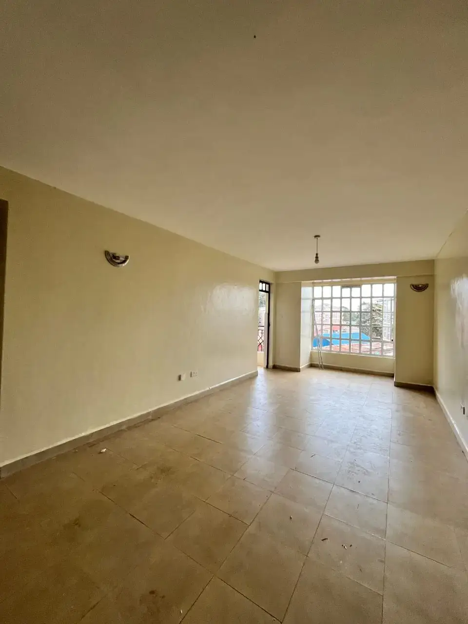 Spacious living room with tiled floor and natural light
