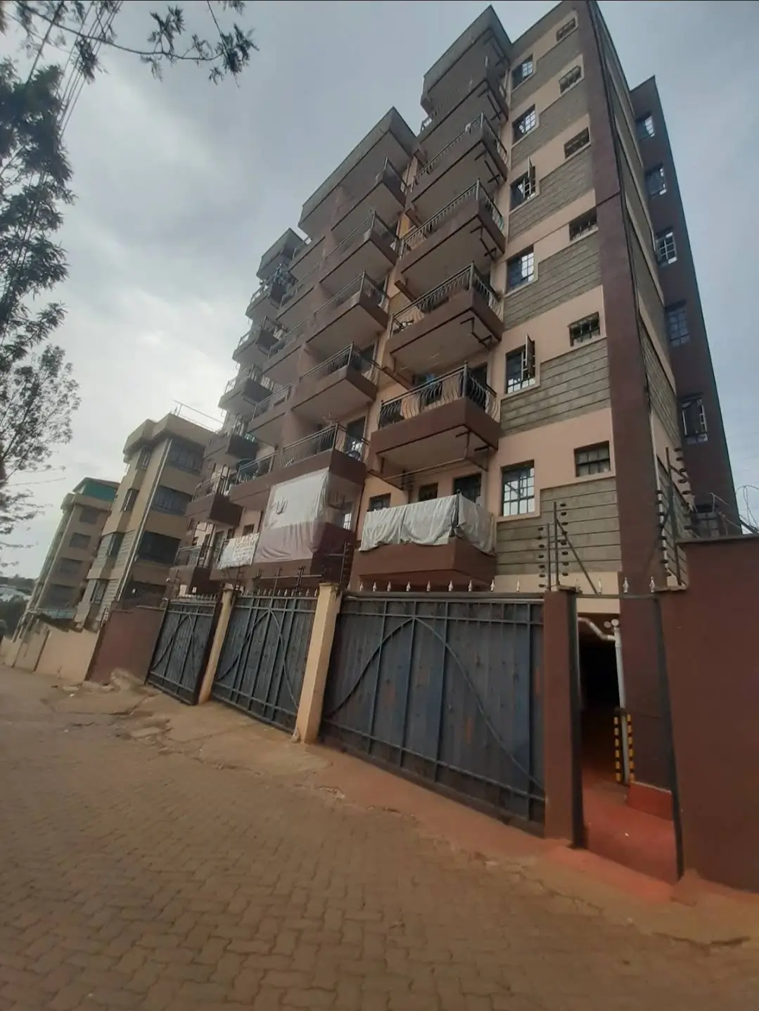 Multi-story residential building with gated compound entrance