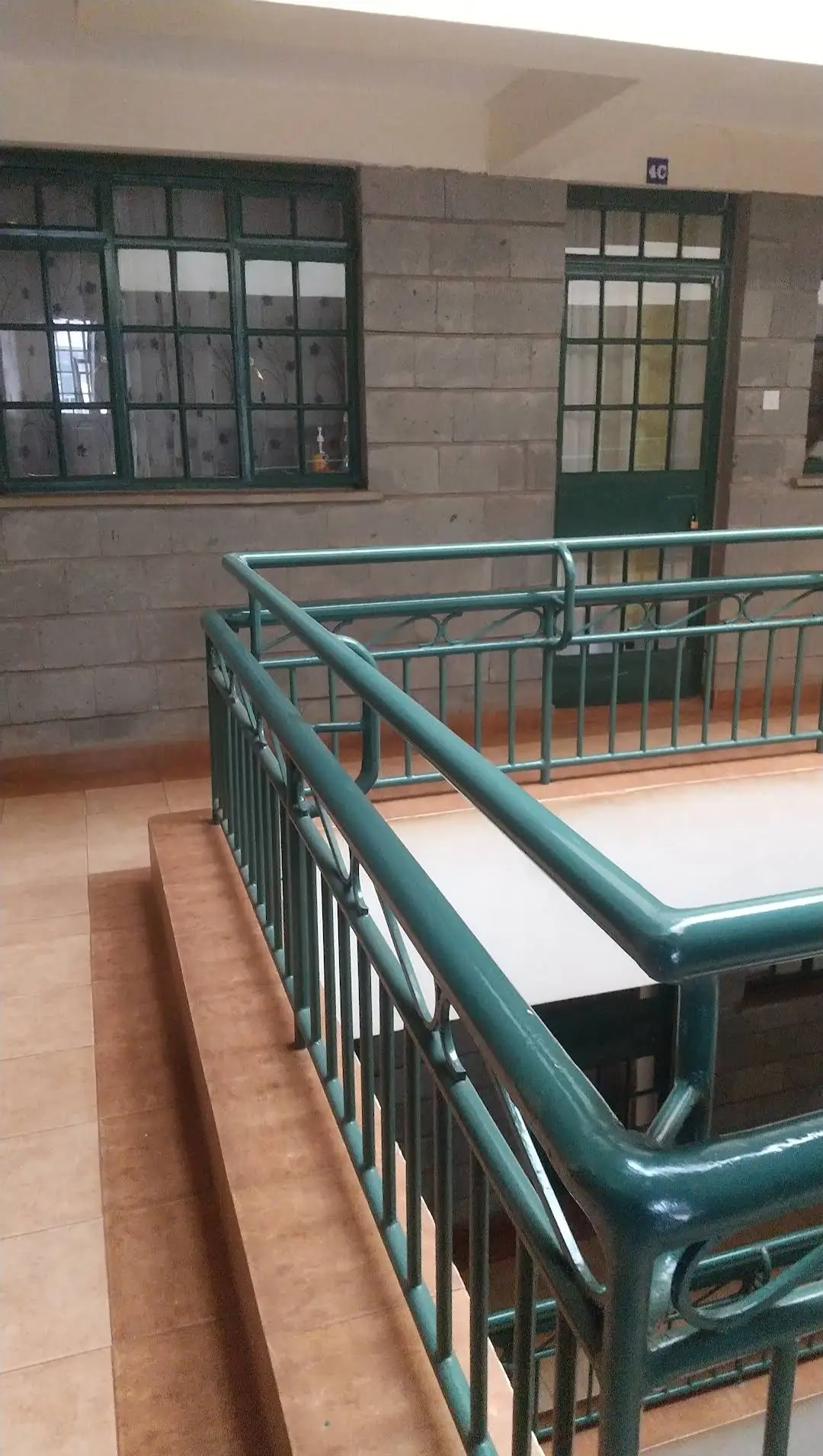 Building corridor with metal railing and tiled flooring