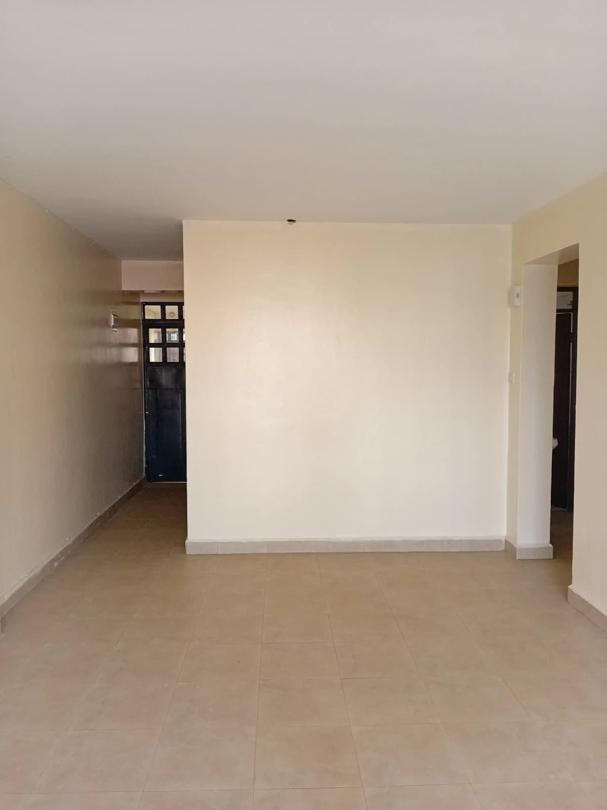 Empty open-plan living space with polished concrete floor
